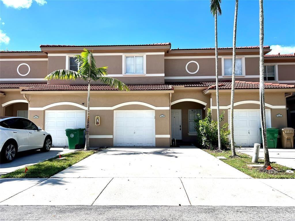 Beautiful gated 4-bedroom, 3-bath townhouse in a prime Broward location! Conveniently located near Nova Southeastern University, Seminole Hard Rock Hotel & Casino Hollywood, highways, and shopping centers, this home offers both comfort and accessibility. Step inside to an open layout featuring laminate flooring throughout and a modern kitchen equipped with stainless steel appliances. A washer and dryer are included for added convenience. Ceiling fans in all bedrooms enhance comfort, while spacious closets provide ample storage. Relax and unwind in the screened-in patio—perfect for enjoying South Florida evenings. The home also includes a 1-car garage for secure parking and large double car driveway.A fantastic opportunity to live in one of Central Broward’s most desirable areas!