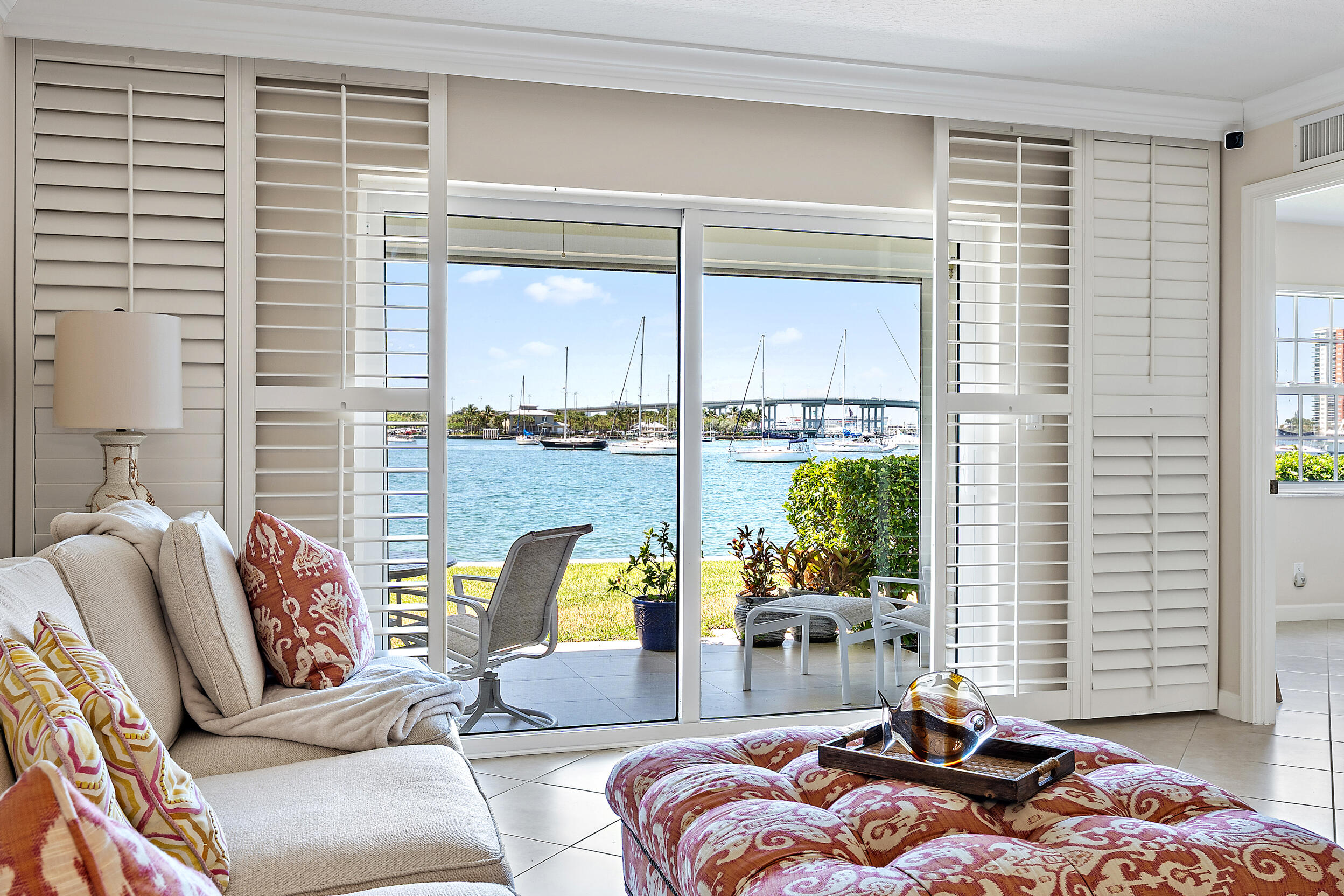 A rare opportunity to own a walkout waterfront residence with panoramic Intracoastal views in one of Singer Island's most charming communities. First-floor waterfront retreat in highly desirable Sugar Sands on Singer Island! Enjoy breathtaking direct Intracoastal views overlooking the southern expanse of Lake Worth Lagoon, where spectacular sunsets become part of everyday living. This 2-bedroom, 2-bath residence offers a coveted walkout design with easy indoor-outdoor flow and front-row seats to ever-changing boat traffic and shimmering water views. The spacious layout offers comfort and privacy, while the first-floor location lives like a waterfront villa. Located within the sought-after 55+ Sugar Sands community, residents enjoy resort-style amenities including a clubhouse, heated pool, tennis, shuffleboard, deeded beach access, and a vibrant social lifestyle.  Live the Singer Island waterfront lifestyle surrounded by beautiful beaches, boating, fishing, waterfront dining and luxury coastal living. Centrally located near Palm Beach, Jupiter, and Palm Beach Gardens, residents enjoy proximity to championship golf, marinas, fine dining, upscale shopping, cultural venues, and Palm Beach International Airport just minutes away. Explore nearby Worth Avenue, oceanfront restaurants, waterfront promenades, and all that makes Singer Island one of South Florida's most desirable coastal communities.