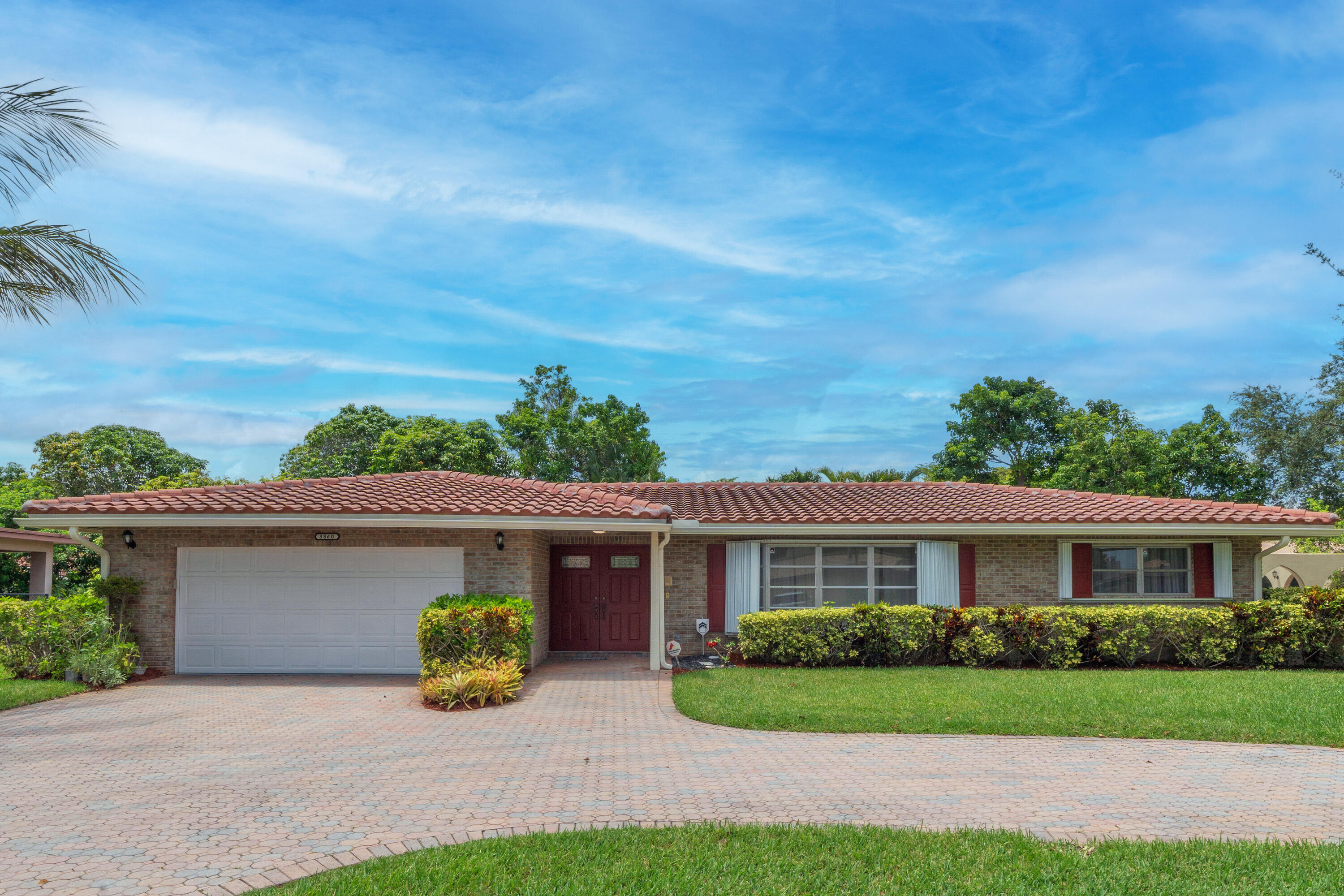 Beautiful 4-bedroom, 2 bath on an oversized 16,197 lot in the heart of Coral Springs! Updated residence with spacious split plan, abundant natural light, and generous Living/Dining areas, Gourmet Kitchen with lots of soft closing cabinets, Granite and Stainless, Breakfast Bar. The primary suite is a private retreat w/en-suite bath and abundant closets. Spectacular property with sweeping parklike land, corner lot with mature trees. Your own Oasis. Massive paver circular driveway, comfortably holds 6 cars. Meticulously cared for executive home with 14 year roof. A rare find!