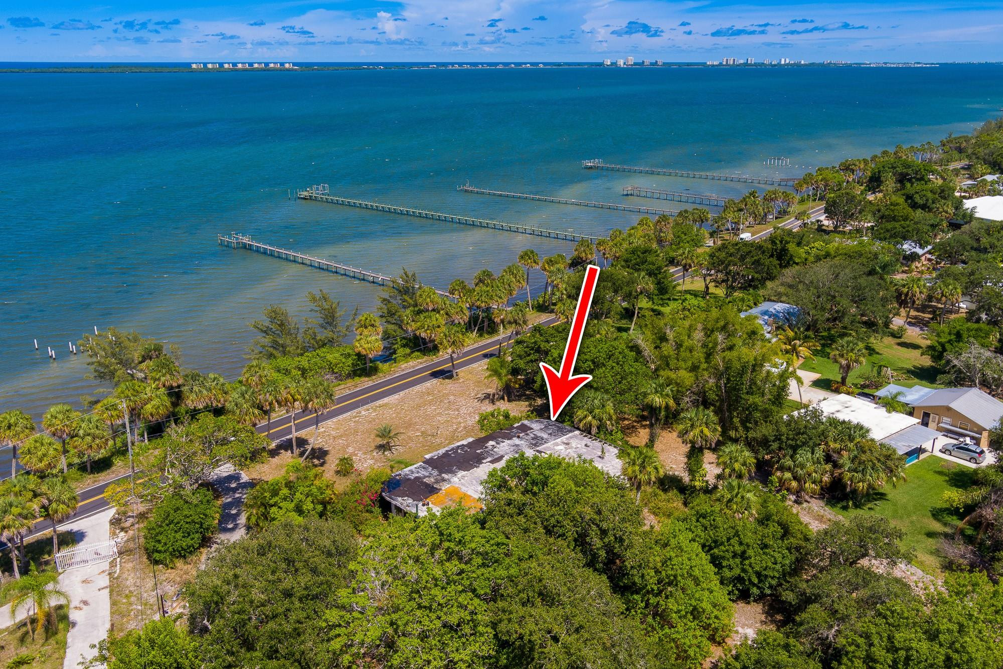 SELLER FINANCING AVAILABLE AS LOW AS 3.885%. TERM SHEET AVAILABLE UPON REQUEST. Purchase this property for the unbelievable value of less than $4.49 per sq ft and $195,900 per acre, with a total of ~8 acres!! Rare opportunity to own roughly 3.5-4 acres of buildable, high and dry land right on the Intracoastal Waterway. Endless potential—tear down the existing home and save on impact fees when you build your dream home! Build a private dock to the existing pier, enjoy direct water access for boating and fishing! You’ll enjoy unmatched privacy, serene views, and the rare flexibility this parcel provides. Renderings are attached with photos to help you envision the possibilities. Whether you’re seeking a luxury retreat or a timeless coastal estate, this property delivers it all!