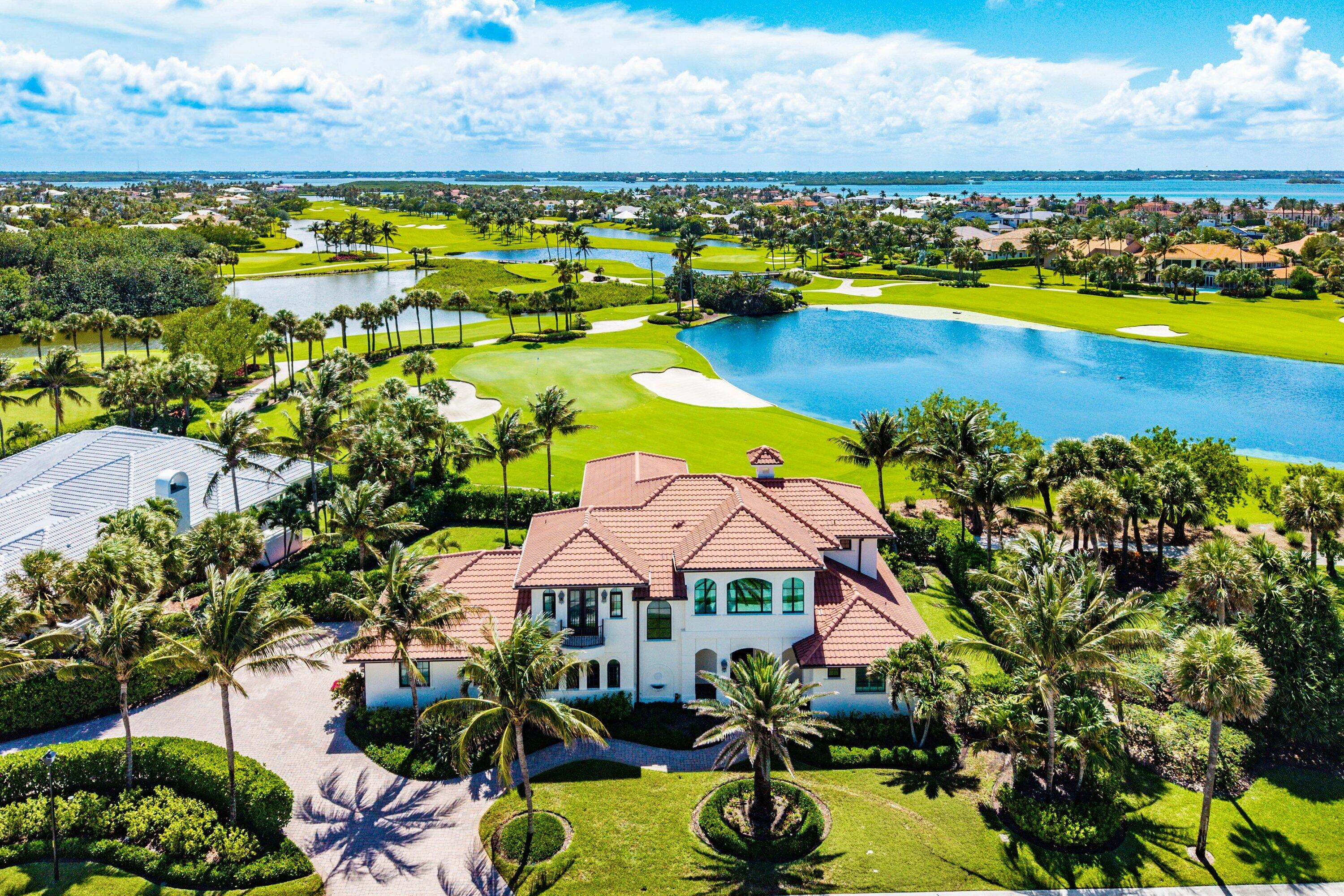 This Mediterranean-inspired smart home blends beauty, sophistication, & modern convenience through thoughtfully integrated home automation systems. The great room features coffered ceilings, a gas fireplace, honed travertine marble flooring, & French doors that frame sweeping views of the infinity-edge pool and golf course beyond. The covered loggia is designed for effortless outdoor living, complete with a fireplace & built-in gas grill. The gourmet kitchen is appointed with professional-grade appliances, custom white maple cabinetry, & quartz countertops. The first-floor primary suite offers hardwood flooring in the bedroom & polished marble finishes in the bath. Three en suite guest bedrooms on the second floor provide comfortable accommodations for guests.  Just steps from the beach, the home also enjoys tranquil lake & golf course views, creating the perfect setting for both sunrise strolls & spectacular sunsets. Sailfish Point offers a full-service marina for boats up to 100 ft, private airport access with US Customs on-site, & an oceanfront country club w dining, tennis, pickleball, a fitness center, spa, & even a helipad.