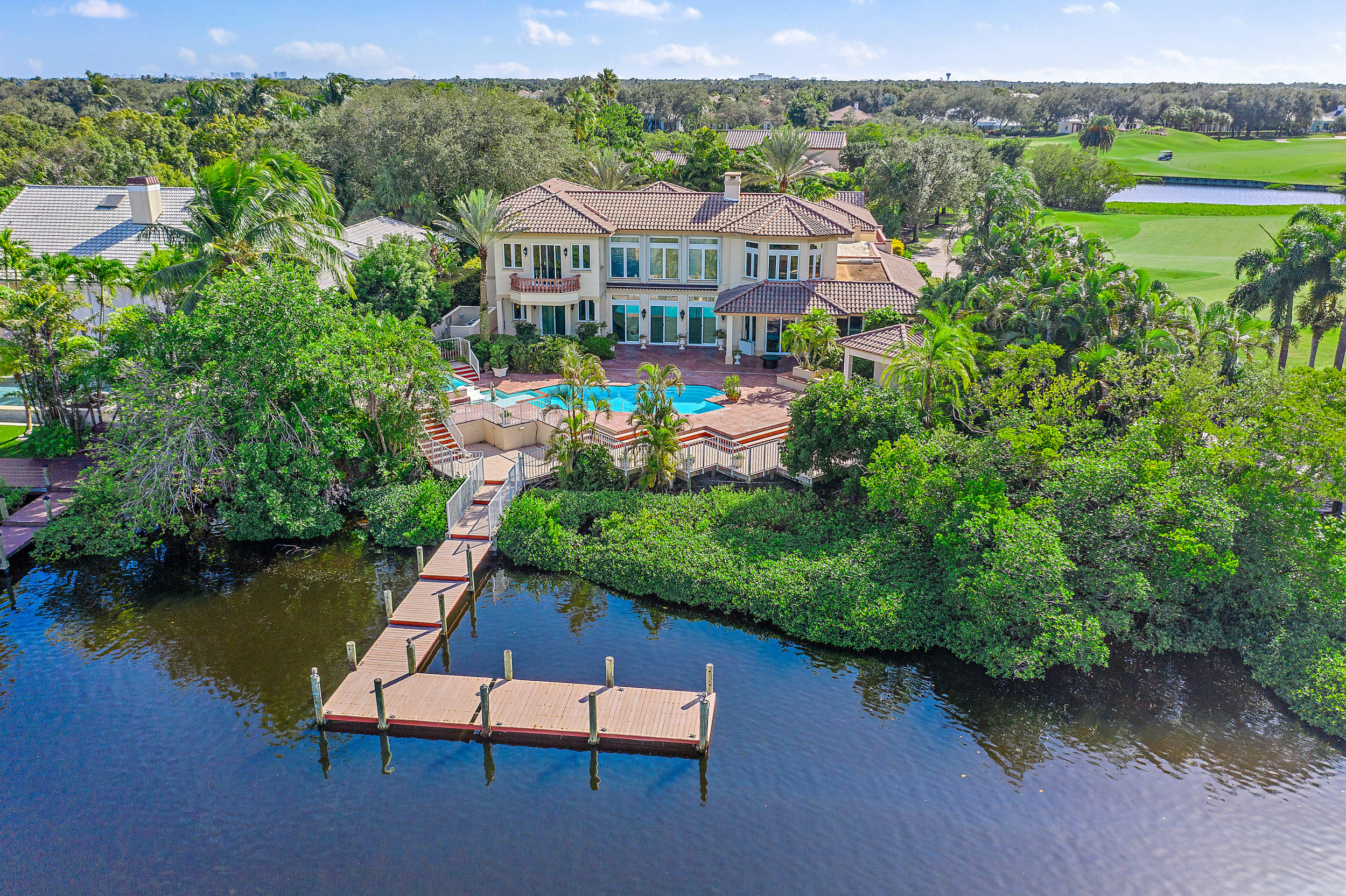 Located on a quiet cul-de-sac in the prestigious Admirals Cove community, situated on a large lot directly on the water, this home features a private dock & unobstructed access to the Intracoastal Waterway, as well as panoramic water and golf course views from a second-floor deck. Lush landscaping throughout the property provides additional solitude as you enjoy the pool, spa, a spacious patio and a covered summer kitchen ideal for entertaining. This magnificent home features an array of formal and casual dining spaces, 5 bedrooms plus a club room/office, 7 ½ baths, a 3 ½ car garage, multiple fireplaces, impact glass windows providing an abundance of natural light, & is conveniently located close to Admirals Cove's acclaimed clubhouse with it's 5-star amenities and recreational facilities.