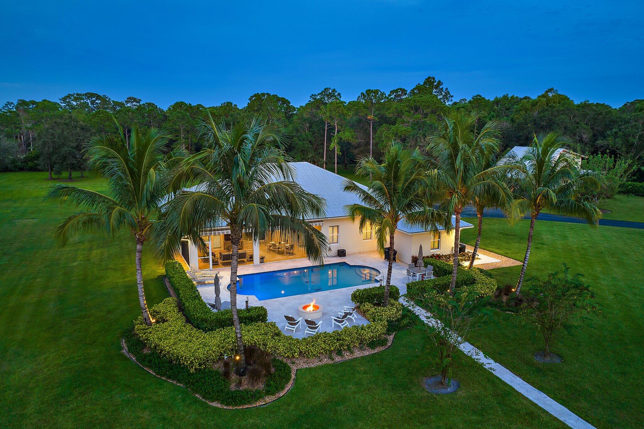 Welcome to Winterhawk Farms - the premiere offering in Jupiter Farms!

A truly unique opportunity that rarely becomes available. Winterhawk Farms expands across 5 sprawling acres of pristinely manicured property and features a Main Residence, Guest House, Pole Barn and Shop. Combining private + personalized equestrian elegance with luxurious residential living, 17593 Winterhawk Trail epitomizes the finest of Jupiter Farms' coveted country lifestyle. A privately gated, newly paved road leads to the Main Residence and Guest House. Offering 2,619 of living and 3,687 total square footage, the ranch-style main house was constructed in 2016. Split floor plan featuring four bedrooms, three bathrooms and a den. Recent kitchen upgrades include layout modifications embracing modern functionality, quartzite counters and a GE Monogram appliance package: 48" built refrigerator, 30" double French door oven and glass cooktop.  Design elements include upgraded LED high-hat lighting, new quartzite countertops in the primary bathroom, soft close hinges on all cabinets throughout, and recently painted interior walls. A screened covered patio overlooks the pool and firepit area, which boasts newly laid Travertine flooring + decking.  The outdoor oasis offers Exquisite tropical sunsets!
 
The two-story guest house was built in 1993 and offers exceptional multi-use space with 2 bedrooms and 1.5 baths. Approximately 1,400 square feet of additional living quarters, separate and private from the main house. Newly added deck and impact sliding glass doors create a bright + airy interior, featuring new vinyl flooring on the first floor.
 
Sited at the rear (western side) of the property, is the Shop, Pole Barn, four paddocks and Arena. Built in 2011, the Pole Barn was upgraded/outfitted in 2022 to a true Pole Barn offering approximately 1,537 total square feet. Upgrades include three 12' x 15' horse stalls with SoftStall flooring, 12' x 15' air conditioned and dehumidified tack room, 12' x 30' hay & storage room, horse wash area with roof, twelve outdoor fans in the barn, and new Hurricane rated roll down shutters at the center front and back of the barn. The 50' x 50' shop was constructed in 2015 with roughly 2,500 total SF under structure and two 600 SF carports, totaling approximately 3,700 total square footage. Featuring an air-conditioned office, 15,000lb automobile lift, and three 14' overhead garage doors. Exceptional accessibility makes storing vehicles or equipment of any size, easy and seamless.