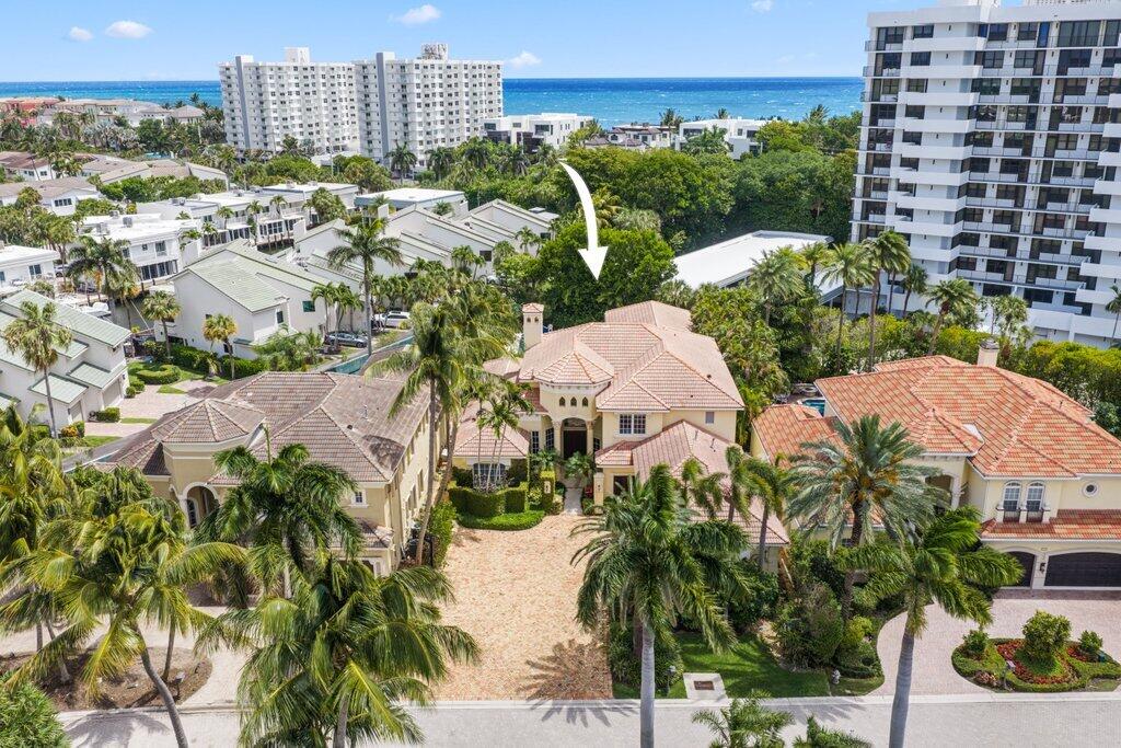 This exceptional Highland Beach estate presents a rare opportunity within the exclusive enclave of Boca Highland Beach Club, including access to the newly renovated, resident-only beach club. Located in Grand Cay Estates, 1 of 18 residences, and set on over 1/3 acre, the property offers nearly 6,000 sq ft under air, delivering privacy, scale, and a true coastal lifestyle. The entry opens to a light-filled great room with volume ceilings, new hardwood flooring throughout, with a  thoughtfully designed layout that creates a natural flow between living spaces. The chef's kitchen is functional and refined, featuring Viking and Sub-Zero appliances, including a gas range, double ovens, quartz countertops, and a substantial island with seating, seamlessly connected to the family room. The primary suite is a sun-drenched retreat, featuring walk-in closets and a newly renovated spa-inspired bath with a free-standing soaking tub, expansive walk-in shower, dual vanities, and a dedicated makeup vanity. The main level also includes a grand office with custom millwork, a private theatre, and a well-appointed guest suite. Upstairs offers four additional bedrooms and a spacious loft. A Chicago brick motor court, three-car garage, and expansive grounds complete the setting, offering ample space for outdoor living and entertaining, complemented by a private pool recently resurfaced and a well-appointed cabana bath. New furnishings throughout. Residents of Boca Highland Beach Club enjoy 24-hour manned security and a newly renovated, resident-only beach club just across A1A. Located in the Town of Highland Beach, known for its limited commercial presence, private police department, and strong sense of privacy, the home offers a quiet, residential setting just minutes from Mizner Park and Atlantic Avenue.