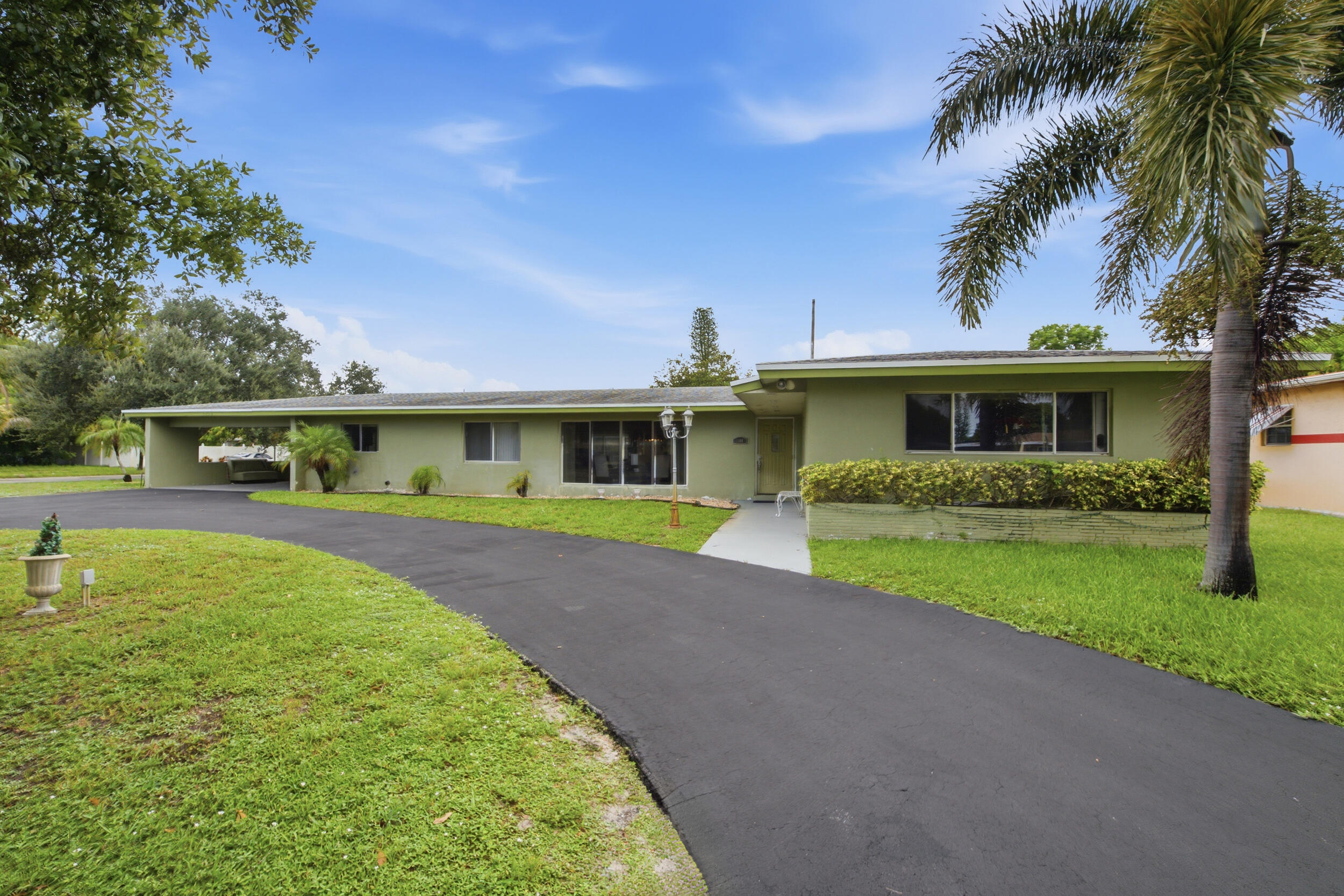 Welcome to this spacious 3-bedroom, 3-bathroom home located in the desirable Melrose Park community of Fort Lauderdale. Situated on a large 12,364 sq ft corner lot, this 2,201 sq ft residence offers comfort, updates, and lifestyle features perfect for South Florida living. Highlights include a new A/C, newly installed impact windows, updated electric panel, and a Titan tankless water heater. The home comes equipped with stainless steel appliances (microwave, range, dishwasher), GE washer, and Samsung dryer. An indoor circular bar adds a unique touch, ideal for entertaining guests. Enjoy the convenience of a 2-car carport, generous outdoor space, and a location close to major highways, schools, shopping, and just minutes from Fort Lauderdale Beaches.