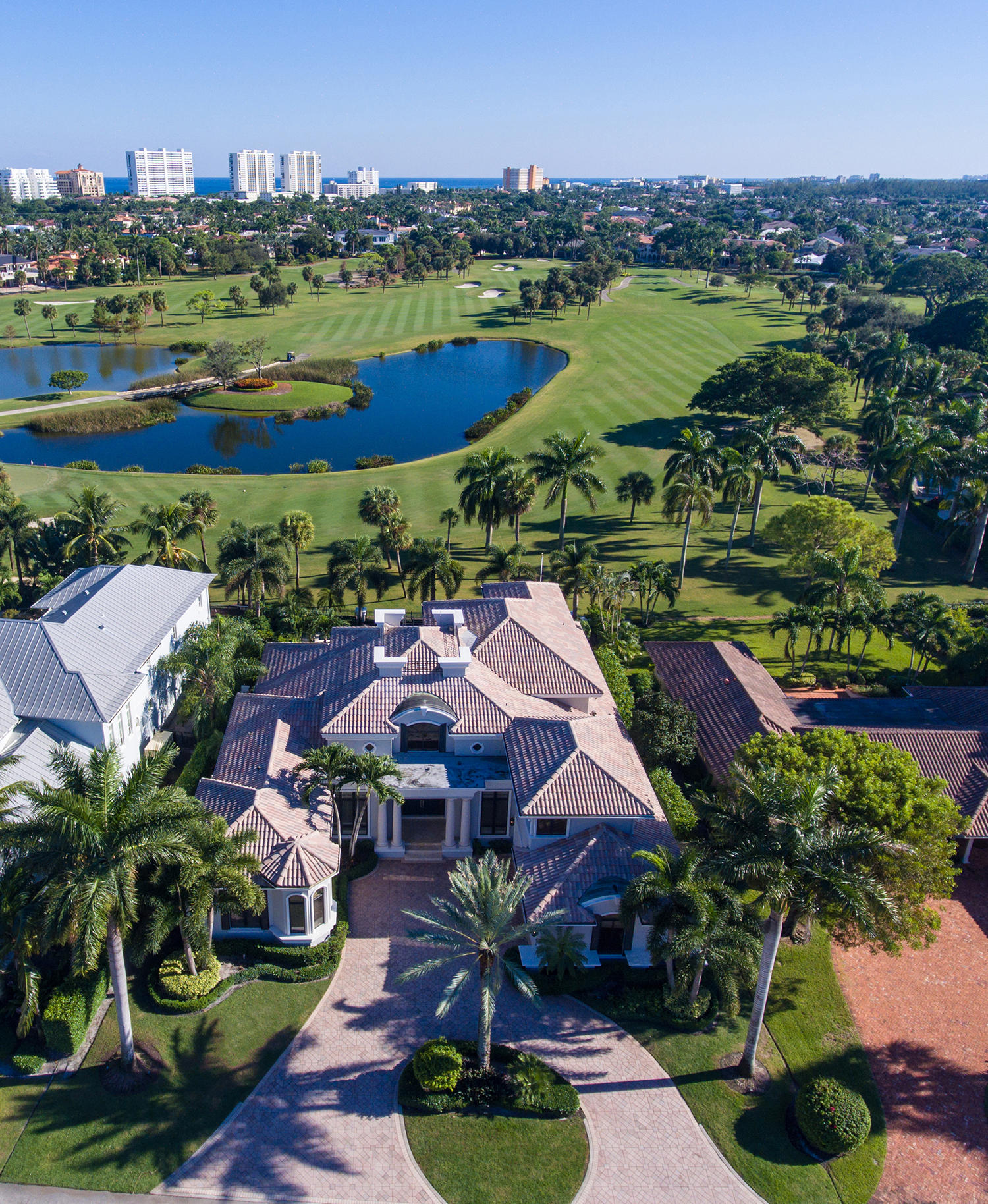 Breathtaking long-range views expand across three lush fairways, centered on a meandering lake, all the way to the beach skyline from this impressive Modern Traditional-style estate facing southeast on the golf course.  Canopied in sumptuous palm trees, the fabulous resort-style outdoor entertainment space provides a dining lanai with grilling station by the sun-splashed pool with waterfall spa.  Manicured tropical foliage also adorns the front grounds where the double-entry drive sweeps to the entrance courtyard. DISCLAIMER: The written and verbal information provided including but not limited to prices, measurements, square footages, lot sizes, calculations and statistics have been obtained and conveyed from third parties such as the applicable Multiple Listing Service, public records as well as other sources. All information including that produced by the Sellers or Listing Company are subject to errors, omissions or changes without notice and should be independently verified by any prospect for the purchase of a Property.  The Sellers and Listing Company expressly disclaim any warranty or representation regarding all information.  Prospective purchasers' use of this or any written and verbal information is acknowledgement of this disclaimer and that Prospects shall perform their own due diligence.  Prospective purchasers shall not rely on any written or verbal information provided when entering into a contract for sale and purchase.  Some affiliations may not be applicable to certain geographic areas. If your property is currently listed, please do not consider this a solicitation.   In the event a Buyer defaults, no commission will be paid to either Broker on the Deposits retained by the Seller. "No Commissions Paid until Title Passes." Buyer pays title insurance, Florida documentary stamps, and all other closing costs for New Construction and land use. Copyright 2016.  All Rights Reserved.
