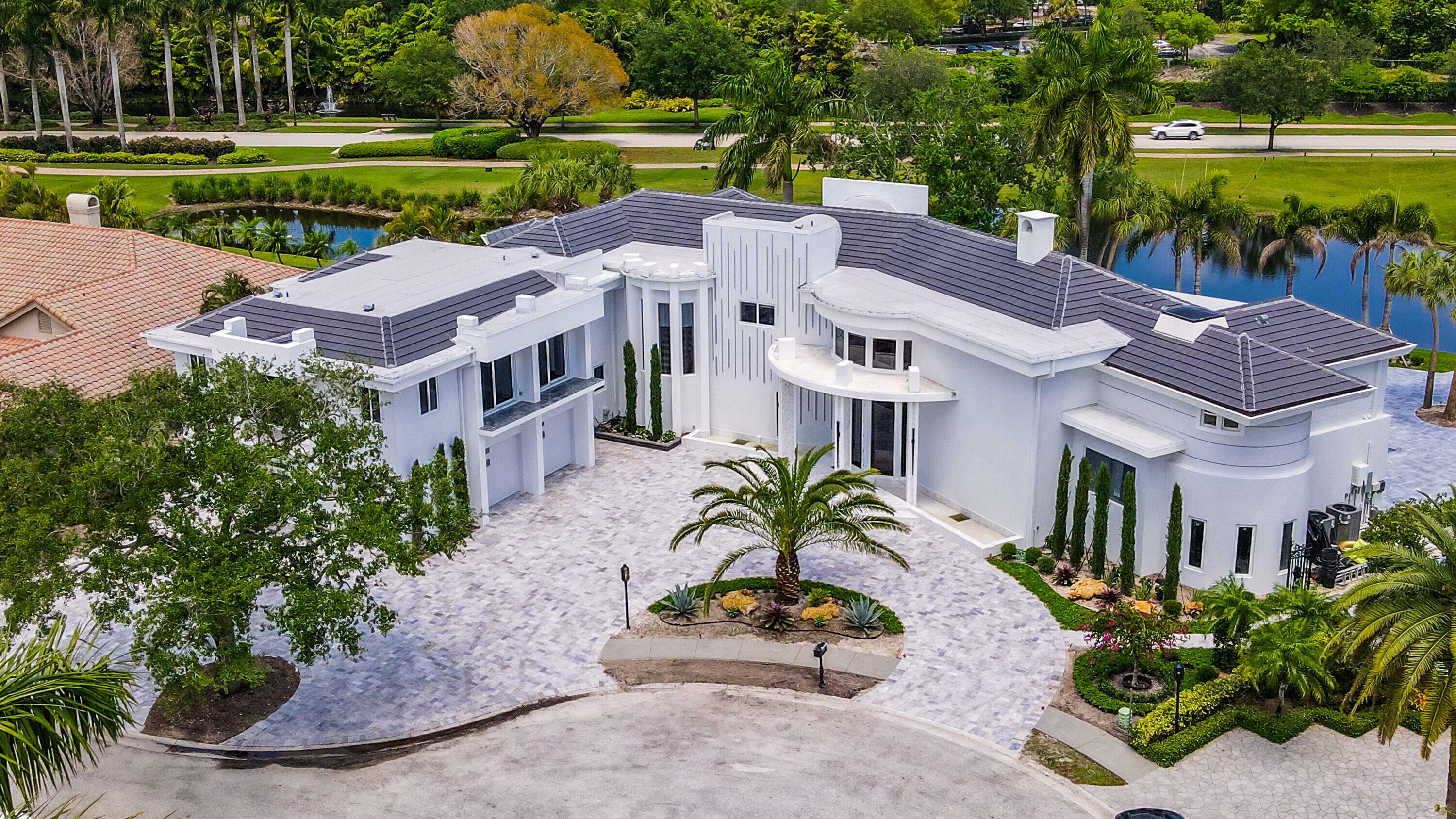 For the most discerning of clients...  Newly rebuilt 10BR, 14bath, 5.5 car garage + office, game room, theater/media rm & elevator to 2nd level. This double lot pool home (Cul-de sac) w panoramic lake & golf vistas boasts a complete attached 3/3 guest house. Floors throughout are 8'' wide solid walnut, 12' dramatic front doors & 10' doors throughout.  3 full kitchens, Huns Krug soft close European imported cabinets, elegant marble countertops, luxury Italian made faucets, Sub-Zero ref/freezer, built in coffee maker, butler's kitchen, gas stoves, 2 tankless hot water heaters, heated pool & jacuzzi, full house generator, theater, open loft areas, private office, built in safe, Bose/Yamaha surround sound, security cameras, new concrete tile roof, SIW impact windows w lifetime warrantee. Onyx fireplace, bar & bathrooms. Each bathroom, uniquely designed & eye catching. Dramatic upstairs & downstairs master suites w HUGE oversized custom designed Huns Krug closets, impressive designer bathrooms and endless exterior golf & lake vistas.  Elevator for personal convenience to fitness room, game room guest bedrooms & huge panoramic balcony overlooking the resort style pool, peaceful long lake and entire par 3 golf hole on the meticulously maintained, lush, tropical, Jim Fazio designed championship golf course & much much more! 
For the most discerning home buyer... all new footings, newly poured slabs, block construction, heavy duty insulation, concrete roof tiles...
Electric bill averages $350/mo.  Sprinkler system uses lake water. Constant heat with 2 industrial tankless hot water heaters...all new electric, plumbing, a/c and clean ducts, (6 zones; 21 sears).  Tropical landscaping makes this a personal paradise to enjoy with friends & family while indulging in the Boca Grove's, mandatory membership, country club lifestyle.  Boca Grove Country Club is an exclusive, private members-only club, offering residents "uncompromising beauty with facilities and activities, that encourage healthy mind, body experiences, a strong sense of community and lasting friendships." Full club membership privileges includes: championship golf, diverse tennis programs, pickle ball, brand new state of the art fitness center, basketball, resort style community pool, comfortable and luxurious remodeled clubhouse, casual restaurants & fine dining with world renowned executive chef, card rooms and much more... Walk to amazing shopping, Boca's finest restaurants and places of worship. Located close to our beautiful world renowned S. Florida beaches and easy access to the FL Turnpike and I95. Live the life of luxury you deserve. Schedule your personal tour today.