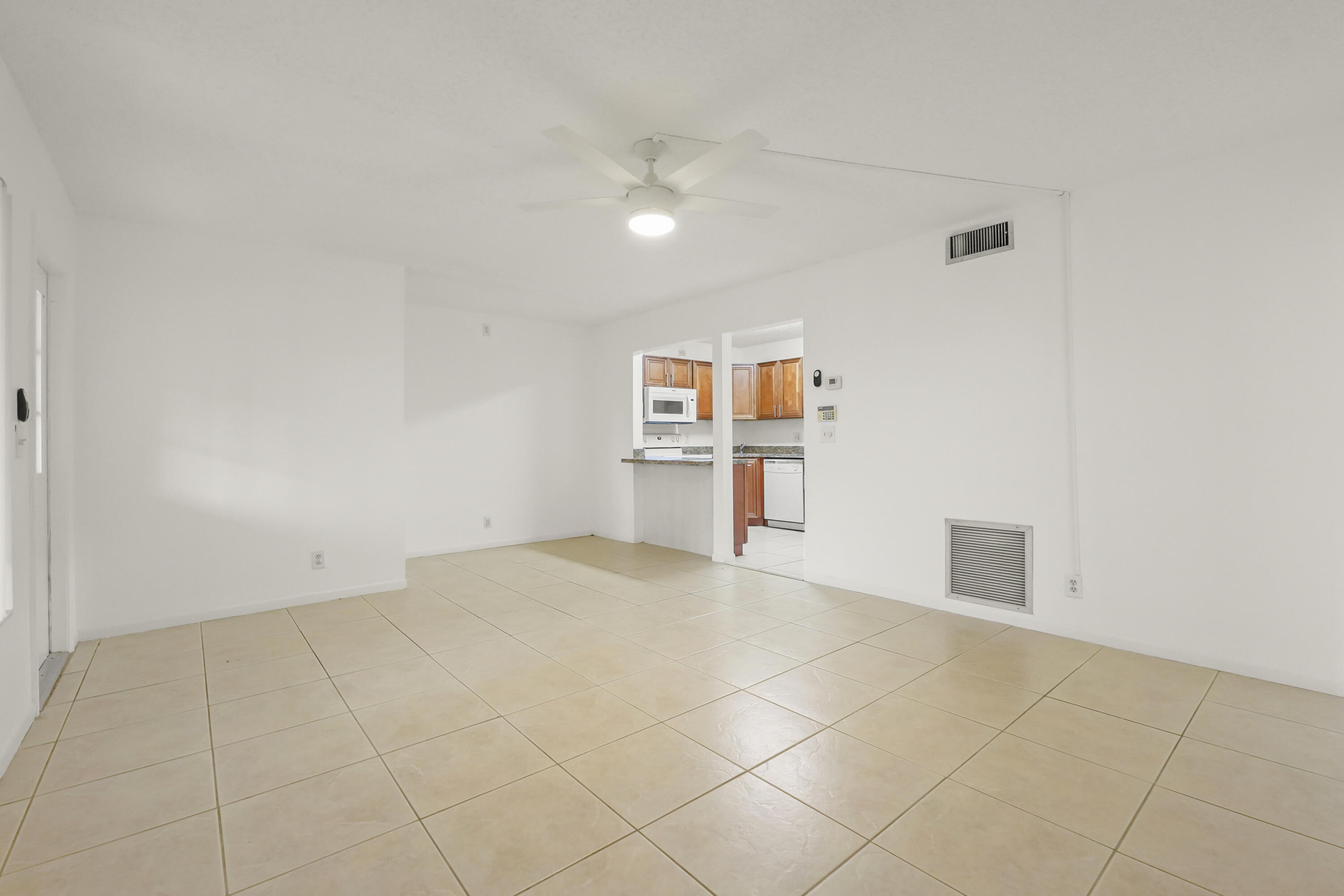 Welcome to a bright and inviting West Palm Beach residence tucked within a beautifully maintained community surrounded by lush landscaping, and peaceful walkways. From the moment you arrive, the home feels fresh, comfortable, and easy to love, with a clean exterior setting, charming garden-style surroundings. Inside, the home offers a light-filled layout with neutral tones, tile flooring, and an easy flow between the living area, dining space, and kitchen. Washer and Dryer inside the unit.   The kitchen features warm wood cabinetry, granite-style countertops, and plenty of workspace, creating a functional and welcoming place to cook, gather, and entertain. The bedrooms feel spacious and serene, with a simple, move-in-ready backdrop ready for your personal style.  The beautiful bathroom adds a fresh modern touch, featuring a clean tiled shower design and polished finishes. Whether you are looking for a primary residence, seasonal getaway, or investment opportunity, this West Palm Beach home combines comfort, important upgrades, and a desirable location close to shopping, dining, major roads, and everyday conveniences.