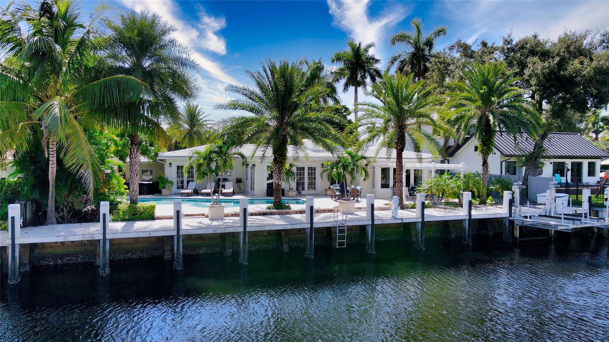 Sited on 100 +/- ft of deepwater in Las Olas Isles, this charming one-level Key West style luxe residence, masterfully crafted by notable architect William Storrs, renovated & expanded in 2015, boasts 3,795 +/- total sqft with 4 stunning bedrooms, 3.5 baths, a 2 car garage & a circular drive coated in travertine that complements its exterior design. The tropically landscaped backyard features a free-form sun-splashed pool set within a large travertine patio with cabana bath, offering endless outdoor dining and waterfront entertainment opportunities. Boaters will enjoy deepwater dockage up to 80 +/- ft all while being just minutes away from multiple waterfront dining options and Port Everglades Inlet by boat, downtown Las Olas, the beach, and Fort Lauderdale/Hollywood-International airport. DISCLAIMER: Information published or otherwise provided by the listing company and its representatives including but not limited to prices, measurements, square footages, lot sizes, calculations, statistics, and videos are deemed reliable but are not guaranteed and are subject to errors, omissions or changes without notice. All such information should be independently verified by any prospective purchaser or seller. Parties should perform their own due diligence to verify such information prior to a sale or listing. Listing company expressly disclaims any warranty or representation regarding such information. Prices published are either list price, sold price, and/or last asking price. The listing company participates in the Multiple Listing Service and IDX. The properties published as listed and sold are not necessarily exclusive to listing company and may be listed or have sold with other members of the Multiple Listing Service. Transactions where listing company represented both buyers and sellers are calculated as two sales. The listing company’s marketplace is all of the following: Vero Beach, Town of Orchid, Indian River Shores, Town of Palm Beach, West Palm Beach, Manalapan Beach, Point Manalapan, Hypoluxo Island, Ocean Ridge, Gulf Stream, Delray Beach, Highland Beach, Boca Raton, East Deerfield Beach, Hillsboro Beach, Hillsboro Shores, East Pompano Beach, Lighthouse Point, Sea Ranch Lakes and Fort Lauderdale. Cooperating brokers are advised that in the event of a Buyer default, no fees will be paid to a cooperating Broker on the Deposits retained by the Seller. No fees are paid to any cooperating broker until title passes or upon actual commencement of a lease. Some affiliations may not be applicable to certain geographic areas. If your property is currently listed with another broker, please disregard any solicitation for services. Copyright 2023 listing company All Rights Reserved.