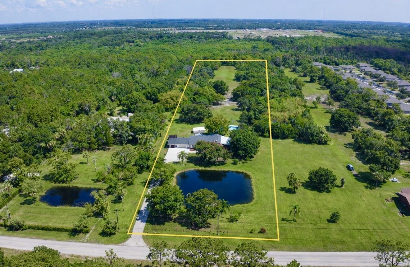 Serene 4-bedroom, 3-bathroom modern farmhouse set on 5 acres with beautiful landscaping and peaceful pond views. Features a brand-new roof, new culvert, impact windows, gutters and water heater. Cozy family room with a charming wood-burning fireplace. Newly renovated kitchen with custom cabinets, quartz countertops, and breakfast nook. Primary suite offers a large shower and walk-in closet. Relax by the pool with farm views or unwind in the Florida room. 2 wells. No HOA, paved road, and conveniently located close to all Vero Beach's amenities.