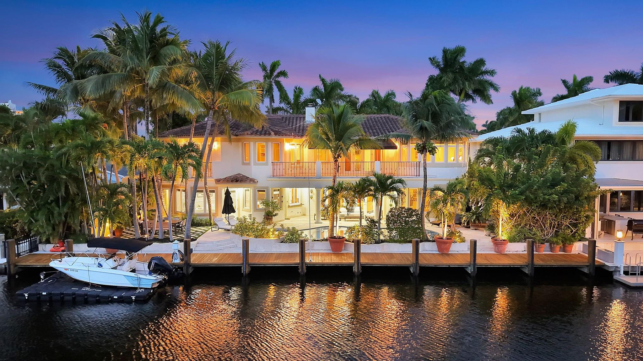 Offered below $300k of October appraised value! 100 ft deep water, walled & gated, island inspired & furnished residence has much to offer. The floor plan is exceptionally flexible with abundant natural light & great entertaining space. Enjoy 2 ground floor bedroom suites. Perfect for entertaining large kitchen/living room, adjoining formal dining room, wine cellar, formal living room with fireplace. Rotunda bar/club room or potential office. 3 bedroom suites upstairs include an extremely expansive primary suite, with private office, gym or third office, separate baths connected with honeymoon shower & large closets. Balcony access. Delightful pool area with cabana bathroom. 3 garage bays & additional guest parking driveway, all walled & gated. Private security also available on this Isle.
