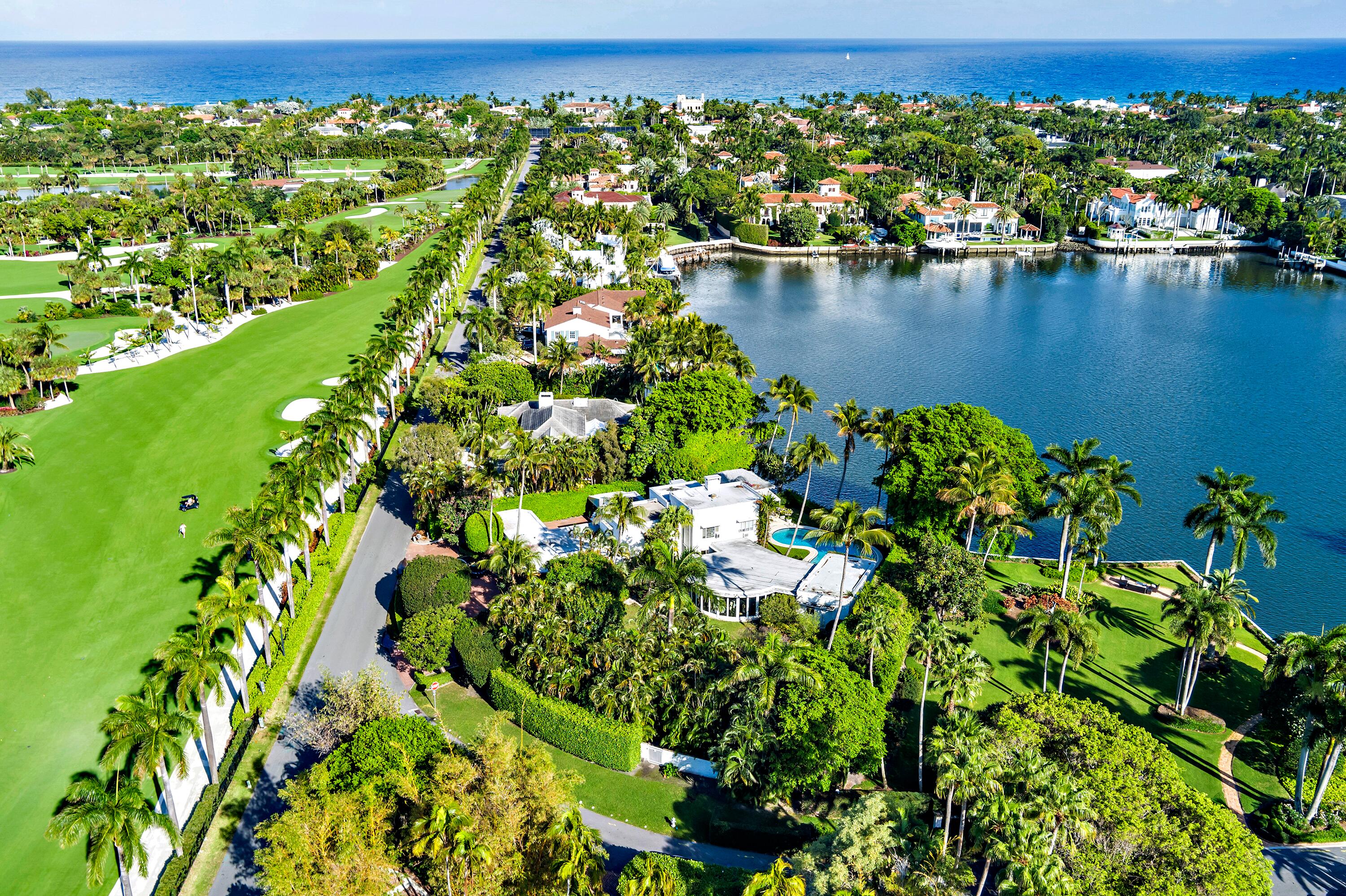 Located on Island Road in the Estate Section of Palm Beach, this 33,301± square foot property offers 107± feet of direct Intracoastal frontage. The property is particularly unique for its rare water views to the south and Everglades Club golf course views to the north. The lot's size, frontage, and premier location present an exceptional opportunity to build a new waterfront estate in one of Palm Beach's most desirable residential areas.  The property currently features a 6,729+/- total square foot Mid-Century residence. The main house includes six bedrooms, six full bathrooms, and one half bath, along with formal living and dining rooms, a kitchen with butler's pantry, and a large party room with bar and kitchenette designed for entertaining.  A separate pool house includes an additional two bedrooms and two full bathrooms.  The grounds have a waterfront pool, as well as a spacious pond and orchid slat house.  Additional features include a two-car attached garage, carport, full house generator, and full house water filtration system.