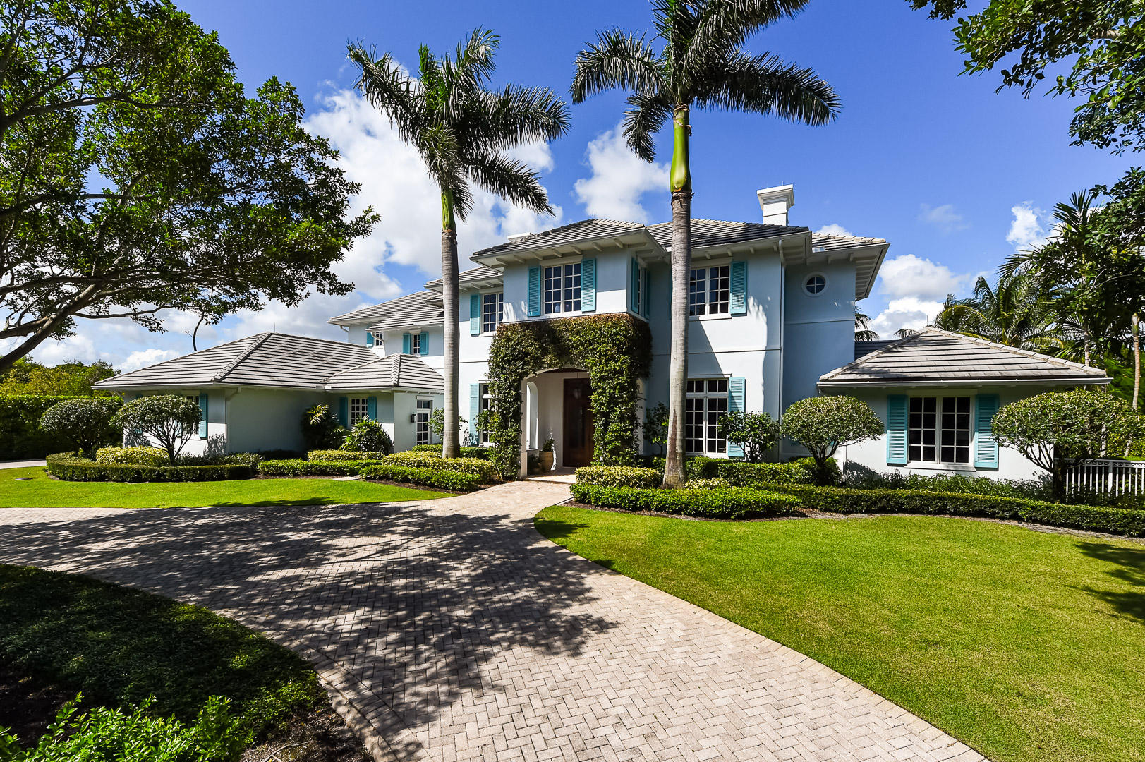 Located in the Seminole Landing, this custom built waterfront house has been impeccably maintained and is ready for you to call home. The five bedroom, four and one half bath home also features a separate home office, an air-conditioned three car garage, 137 feet of water frontage and dock. When entering through the front door, you immediately notice the spaciousness of the 12 foot high coffered ceilings; the adjacent living room and formal dining room are filled with of natural light - showcasing the attention to detail. Off the living room are three sets of French doors that open to a covered lanai that overlooks the 40' long pool and heated spa, making this home perfectly laid out for indoor and outdoor entertaining. The open kitchen offers plenty of marble countertops and beautiful wood cabinets to satisfy any chef; as well as top of the line appliances, natural gas cooktops, center island and over sized sinks. The kitchen is beside a casual family room with fireplace and breakfast nook. Then from the family room, three more French doors open to an outdoor seating area with summer kitchen / grill.   On the second floor is a spacious master bedroom with his and her closets and  a covered balcony overlooking the dock and waterway.  Down the hall are three more guest rooms as well as a large covered balcony with flat screen TV.    The home was built with the finest materials and to all the latest building codes, including poured concrete block construction with all impact rated windows and doors, concrete tile roof, and a full house generator.    Seminole Landing is conveniently located in between PGA Blvd and Donald Ross Road, sharing the same entrance to the Seminole Golf Club.  Seminole Landing is home to some of the highest priced homes in Palm Beach County.