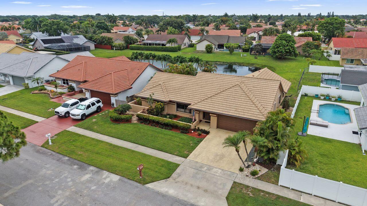 Beautifully maintained 4BR/2BA lakefront pool home in highly sought-after Sun Valley! Situated on an oversized lot, this light & bright home features a spacious split-bedroom floor plan, high ceilings, abundant natural light, and beautiful lake views. The updated kitchen offers modern finishes and ample cabinetry. Enjoy Florida living from the private pool and patio area complete with a motorized sun shade and cabana bath. Major updates include a brand-new A/C, hurricane shutters, and a 2008 direct-to-deck roof, which may qualify for additional insurance savings. Freshly painted and move-in ready, conveniently located near houses of worship, shopping, dining, parks, and major roadways. Low HOA and priced to sell!