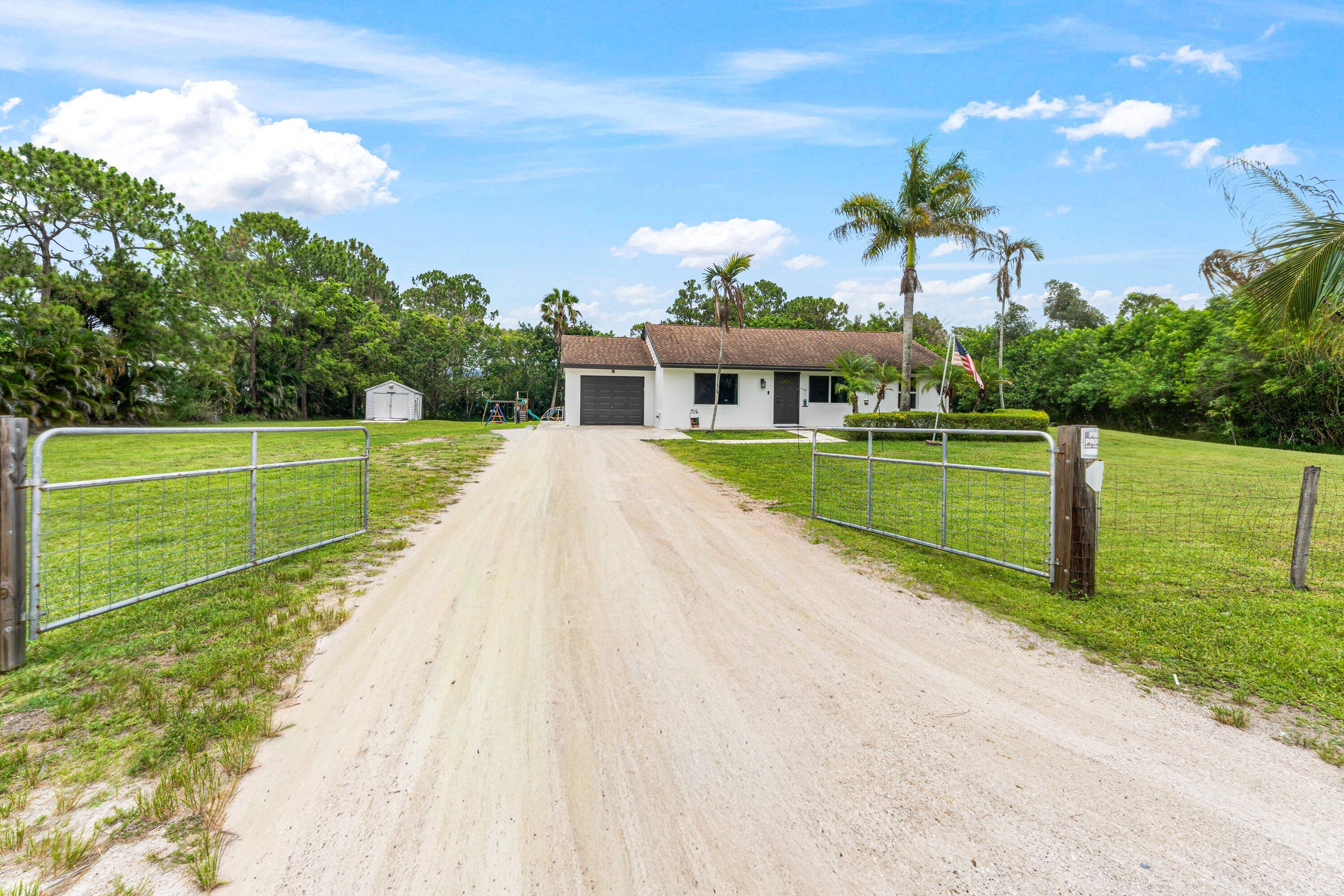 Don't miss this opportunity to own this home in Loxahatchee for under 600k! Situated on just under 1.5 acres, this 3-bedroom, 2-bathroom home offers the perfect combination of privacy, space, and value. Inside, you'll find an upgraded kitchen featuring granite countertops, stainless steel appliances, and ample cabinet space. Major updates have already been completed, including impact windows, a new A/C in 2024 and a roof replacement in 2014, providing peace of mind for years to come. Go outside and enjoy the expansive covered and screened patio, ideal for entertaining, relaxing, or taking in the peaceful surroundings. The property also includes a storage shed, offering additional space for tools, equipment, or hobbies.
