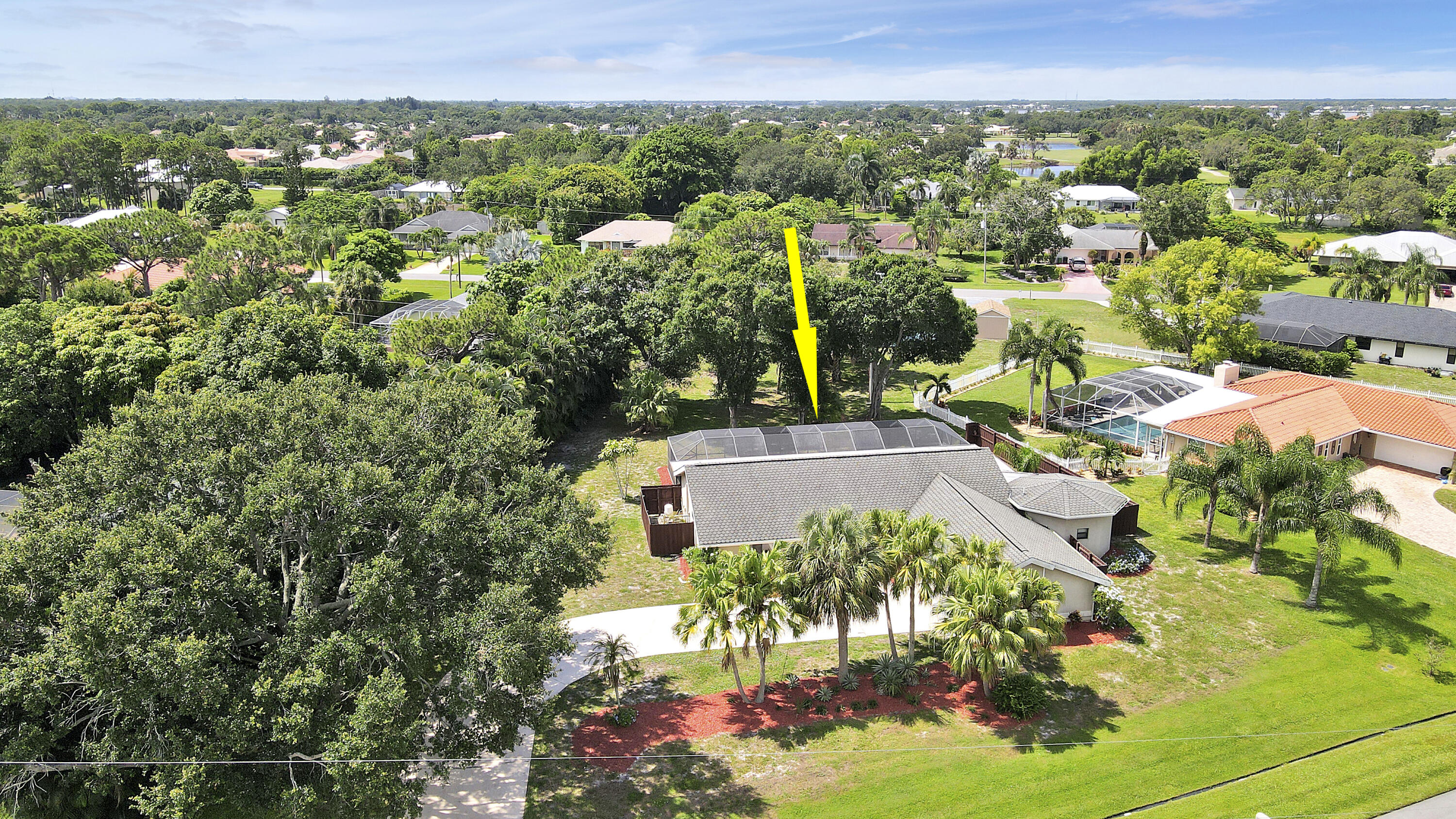 Opportunities to own a pool home on a HALF-ACRE lot in Port St. Lucie are increasingly rare, especially in the heart of coveted Sandpiper Bay! With no HOA, this property offers exceptional space, privacy, and endless possibilities for outdoor living, future enhancements, discreet storage for a boat or RV, or simply the luxury of elbow room. The beautifully renovated interior is designed for effortless living and comfortable entertaining. Natural light pours through wide French doors, illuminating the open great room and enhancing the home's bright, connected layout. Anchoring the space is a crisp white kitchen featuring granite countertops, a generous center island, Frigidaire stainless steel appliances, deep drawers, and bar seating that easily transitions from casual mornings to relaxed gatherings. The spacious living area opens to a screened lanai with a crystal-blue pool and covered patio, creating an inviting extension of the home that can be enjoyed year-round. A flexible den with an ensuite bath and private entrance offers excellent versatility as a home office, flex space, or small guest suite. The owner's suite provides a comfortable retreat with double closets and a beautifully renovated bath featuring dual sinks and a frameless tile-surround shower with a built-in bench.  An attractive scalloped architectural shingle roof adds both durability and character. Ideally located just minutes from riverfront parks, golf, dining, and area beaches, this property delivers privacy, land, and style without HOA fees or restrictions. Offered at $600,000, the renovations, pool, half-acre homesite, zero HOA, and move-in-ready condition set this property apart from the rest of the market.