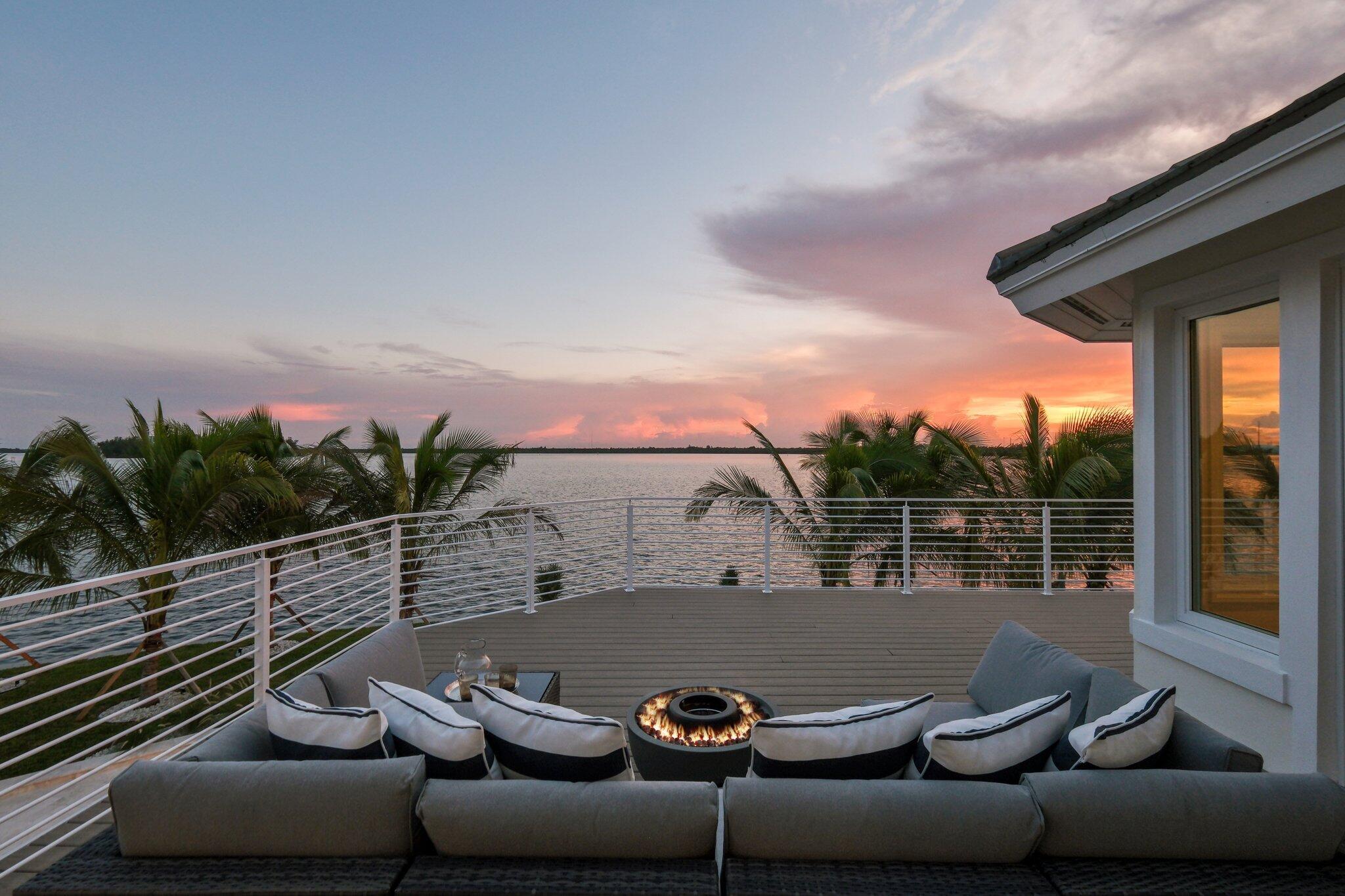 Custom new transitional coastal estate re-built and finished in 2024, located on a 0.61-acre riverfront lot with 212FT of new seawall and dock. This 5,885 SF masterpiece offers five en-suite bedrooms, an office, two half-baths, and a 3-car garage. Features include impact glass, soaring ceilings, a first-floor primary suite with stunning views, and a chef's kitchen with Viking/Sub-Zero appliances, custom bar, and a 20-ft gas fireplace wall. Rare marbles, quartzite, and porcelain throughout. This luxurious retreat features a smart home, quad ACs, lush landscaping, and a new heated pool and spa. Wildlife, islands, and rich, wide Indian river views on your island retreat. Steps to the beach, entertainment, and local executive airport. Extensive upgrades list!
