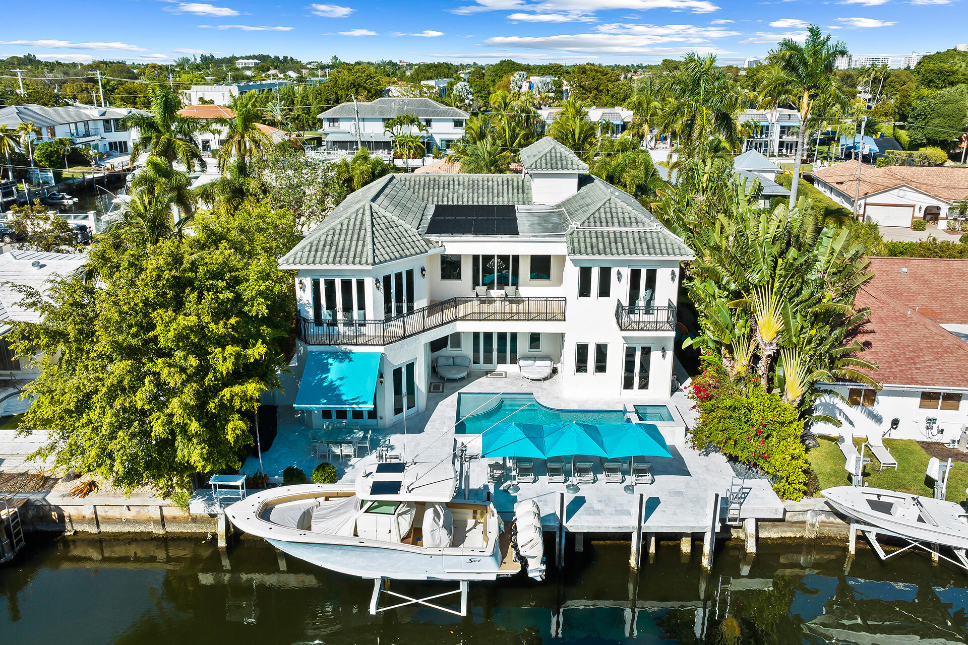 Contemporary tropical oasis situated majestically on  deep water in East Boca Raton. This coastal estate features remarkable craftsmanship with sophisticated interior design. Sprawling 20 foot plus ceilings greet you as you enter this fairytale home. The elegant open concept boasts an updated lavish kitchen. A newly installed and expanded pool deck, freshly renovated and redesigned pool, newly installed batter piling on Seawall, and a newly installed 20,000 lb boat lift, complete the waterfront experience.  A marble staircase and elevator lead you to the second floor with never ending water views. The thoughtfully planned  master bedroom includes a sitting area for a morning sunrise relaxation, a resort like spa bath, and expansive balcony views. Impact glass, Reverse osmosis water filtration through the entire home, Solar power and a bright southern exposure make this a dream come true!
5th bedroom is actually set up as an office currently, but could be reorganized as a bedroom if desired.