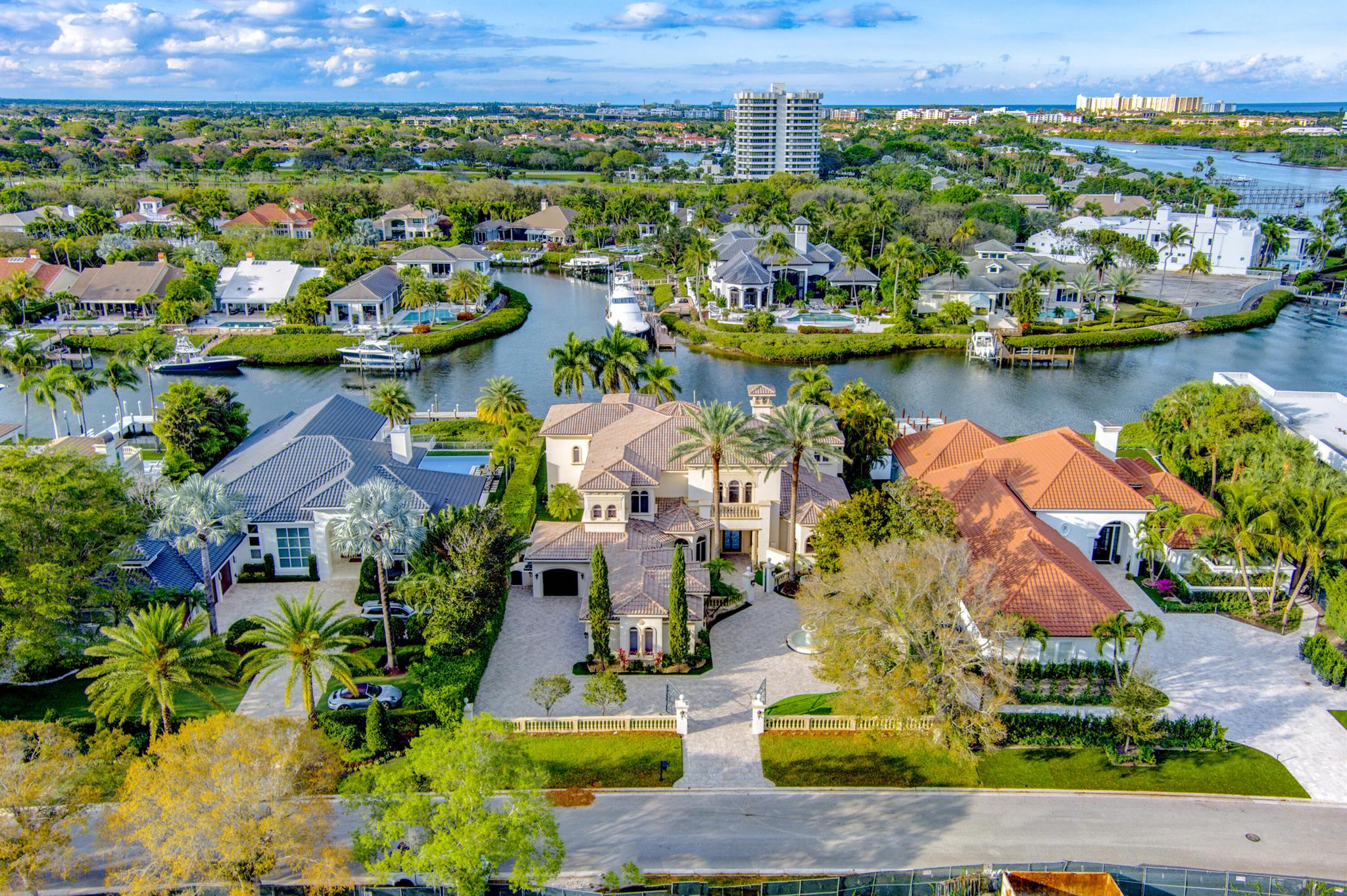 This estate exemplifies luxury living in one of Florida's most sought-after communities. Welcome to a grand estate located in the prestigious Admiral's Cove community in Jupiter, Florida. This custom-built residence, constructed in 2002, offers 7,446 square feet of living space, featuring 6 bedrooms and 9 bathrooms (7 full and 2 half) The home boasts Jerusalem marble flooring, a cast stone fireplace, and a custom 9-foot radius iron and glass front door. The gourmet kitchen is equipped with top-of-the-line appliances and cabinetry. A media room and a spacious second-floor family area enhance the living experience. Each of the additional bedrooms includes an en-suite bathroom. Primary Suite: Located above the primary bedroom is a dedicated exercise or meditation space, complete with sauna and steam shower. The home along with the wrap around balconies offer expansive INTRACOASTAL water views! Beyond the vanishing edge pool and spa you"ll find 110 ft of waterway with room for a yacht up to 80 ft, a private dock with boat lift, and a brand new floating launch for 2 Jet ski's, paddleboards and kayaks. The full service and storm protected marina can accommodate larger vessels. This home also offers views of passing marine wildlife, such as manatees and various seabirds. Residents of Admiral's Cove have access to a range of amenities, including a clubhouse, golf course, tennis and pickleball courts, and a world class spa and fitness center.