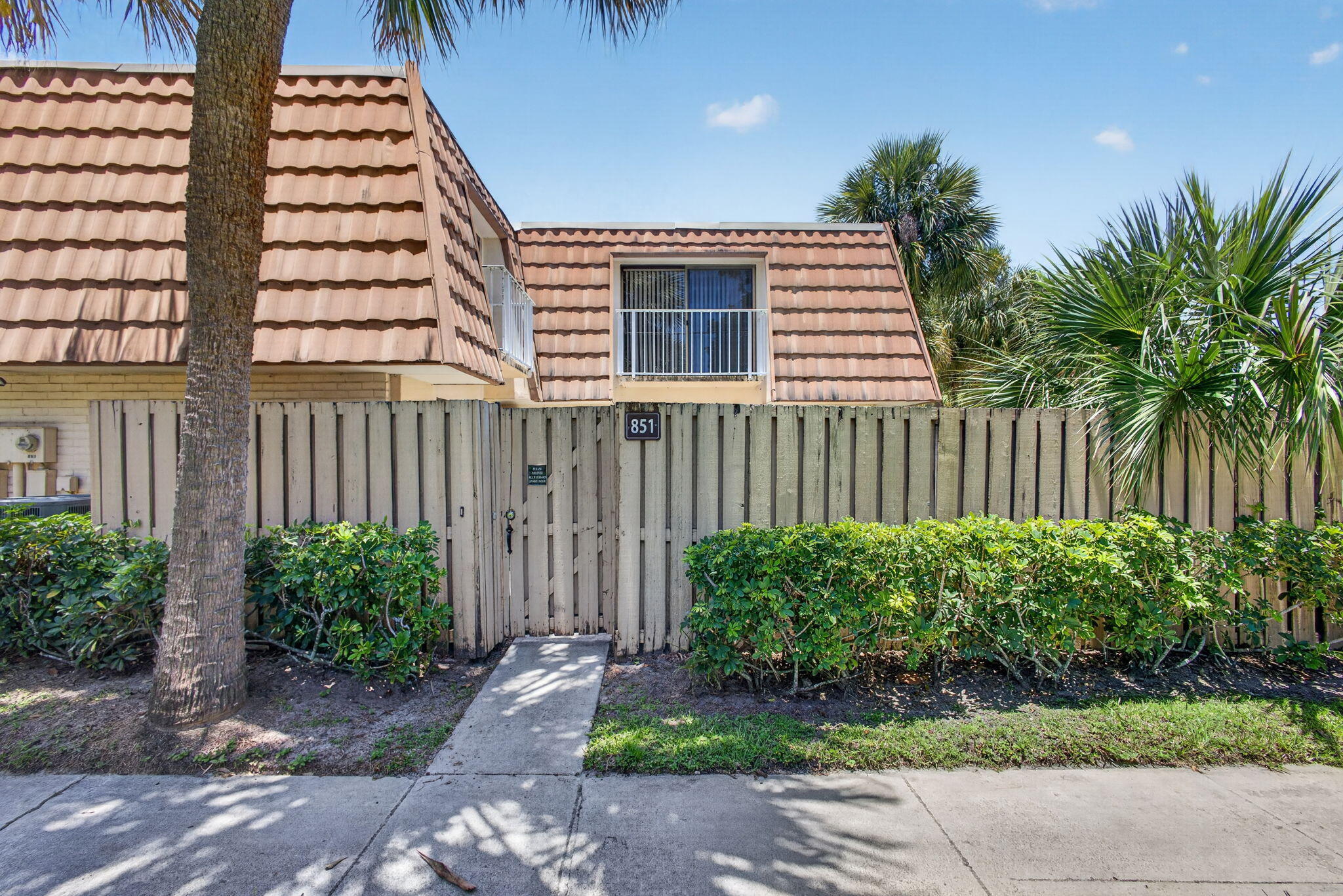 Well-maintained townhome in gated Waterside Luxury Townhomes, available for lease! Private fenced courtyard entrance leads to a spacious patio shaded by palms. Inside, tile flooring, vaulted ceilings, and a wood staircase set the tone. Kitchen features wood cabinetry, granite counters, tile backsplash & stainless appliances. Convenient half bath and in-unit washer/dryer downstairs. Upstairs, the primary suite features wood-look flooring, a private balcony, large mirrored closet, and ensuite bath with walk-in glass shower & dual vanity. Additional bedroom offers a spacious walk-in closet; second full bath has tub/shower combo. Community amenities include pool, clubhouse, fitness center & basketball court. Close to schools, shopping & new ballparks.