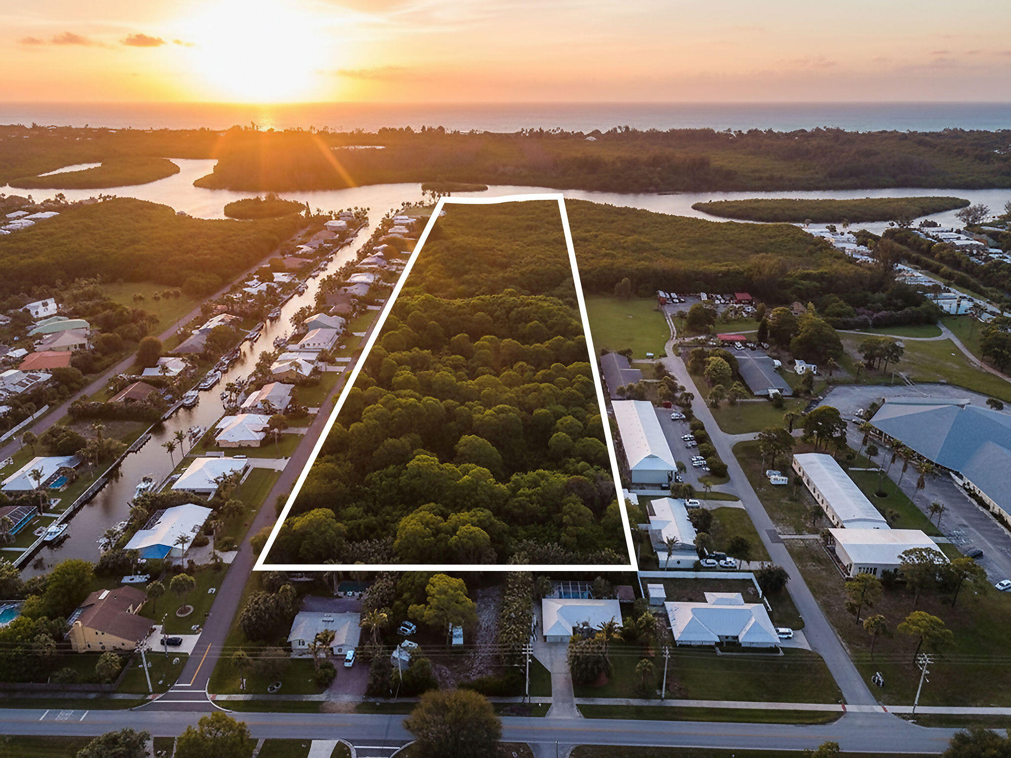 Rare opportunity to own a 12.56-acre waterfront parcel on SE Delafield Street in the heart of Hobe Sound. Offering over 300 feet of waterfront frontage, this expansive property provides exceptional privacy and endless potential to create a private estate or family compound. The treed lot offers a beautiful natural setting and would require clearing, creating a blank canvas for future development. Public water and sewer are available on the street. Ideally located just minutes from pristine beaches, golf courses, Jupiter Island, and the best of South Florida's coastal lifestyle. A property of this scale and waterfront presence is an exceptionally rare offering in today's market, making this an exceptional offering in one of South Florida's most desirable coastal communities.
