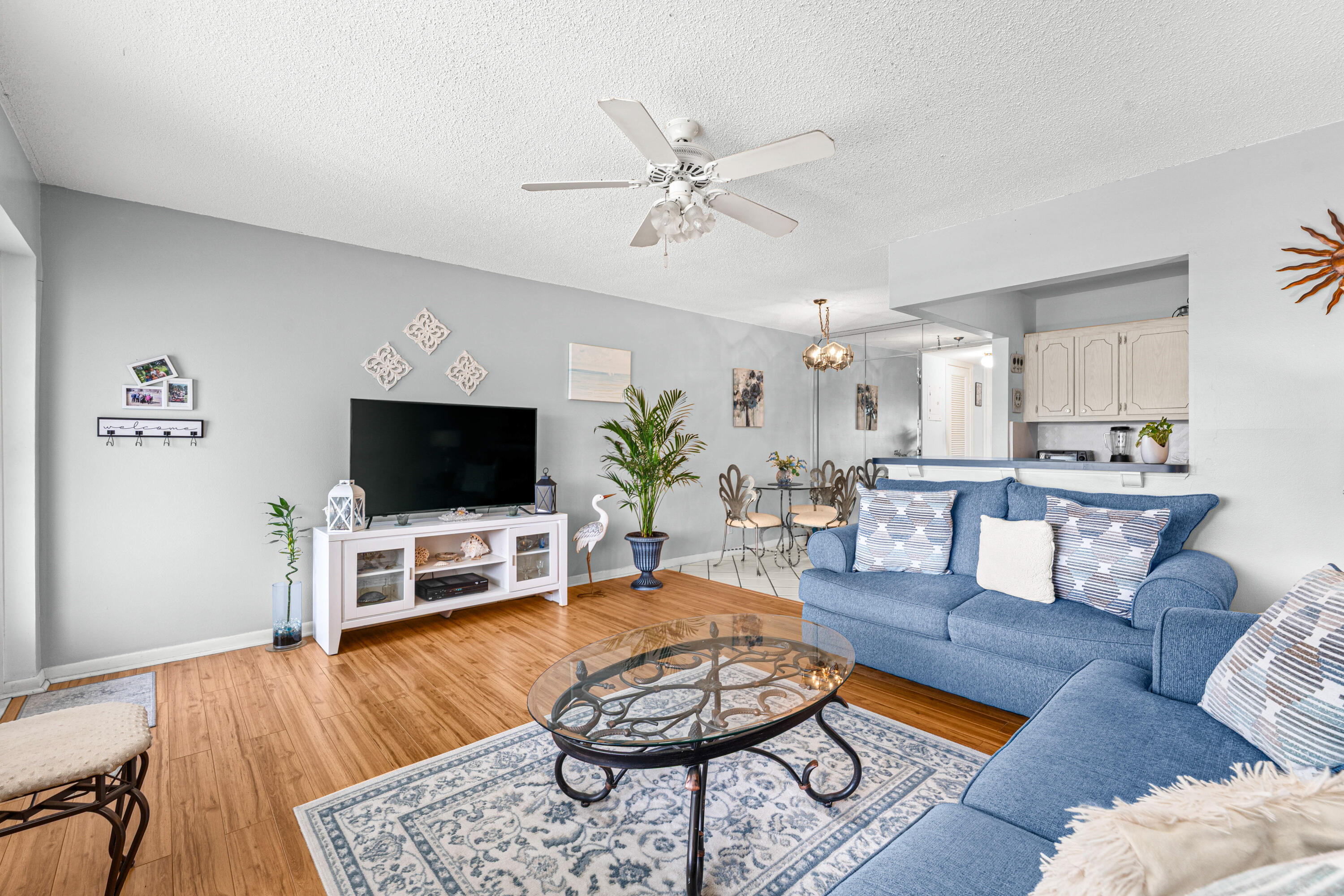 Welcome to easy South Florida living in the amenity filled 55+ community of Century Village! This bright and charming 1BR/1BA second-floor condo offers comfort and peace of mind with a NEW ROOF (2023), two newer wall A/C units (2023 & 2024), newer water heater, and NO assessments. Features include no carpet, spacious bedroom with built-in closet shelving, large walk-in storage/pantry, dining area with barstool seating, patio/sitting room with greenery views, and can be furnished or unfurnished. Assigned parking + guest parking. Enjoy resort-style amenities: gated security, 1,200-seat theater, pools, pickleball, tennis, bocce, sailing, clubs, and more - minutes to downtown West Palm Beach. Excellent value and ready for its next owner, bring all offers. Recently appraised over list price!