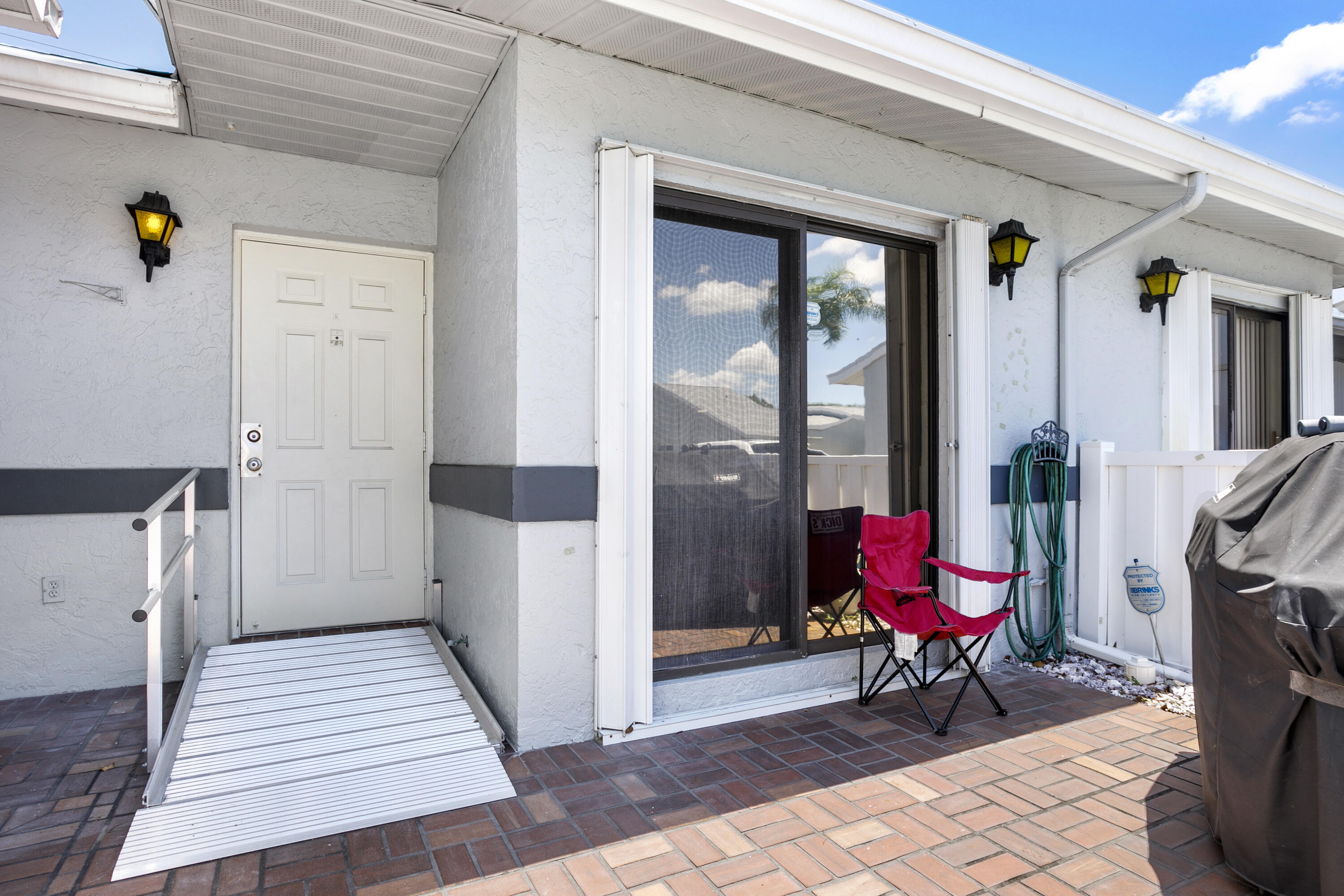 Welcome home to this beautifully completely renovated 2-bed, 2-villa with one car garage offering a spacious split-bedroom floor plan.  The villa was gutted and completely renovated in 2021. The entire villa, including the spacious Lanai, has beautiful, easy to clean, wood-looking tile floors throughout.  The kitchen has been opened up to the living/ dining area and enlarged with upscale cabinetry featuring under the cabinet lighting, crown molding.  A 76-inch sideboard has been added with upper cabinets, also with under-the-cabinet lighting. with 2 sets of 3, 36-inch drawers, and a granite counter for the perfect spot for your small appliances.  The kitchen comes with recessed lighting and a ceiling fan.  Higher end appliances include refrigerator, microwave oven, dishwasher, and stove.