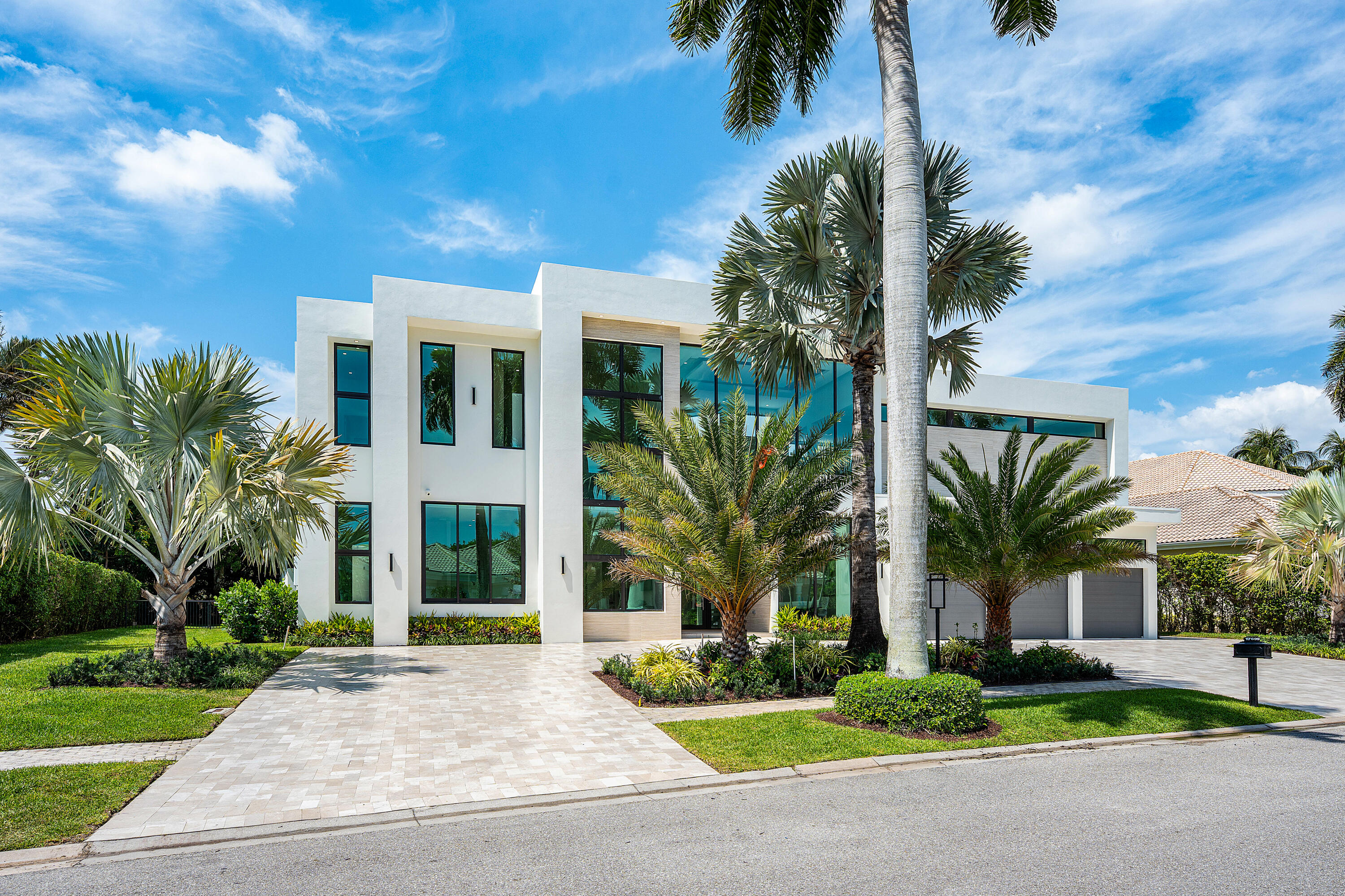 A new jewel has been added to the St Andrews Country Club enclave of 'Lake Estates' in this just completed 2025 contemporary two story renovation and addition, representing the latest in dramatic design and features in country club living. Light fills every room and space with soaring ceilings and expansive glass, from front morning sunrises to rear evening sunsets. The entry foyer opens to a great-room, from which are a first-floor ensuite bedroom, office, dining area, family room, dining and dinette areas and a full back kitchen. The first-floor primary suite features dual bathrooms/walk in closets, sitting area and wellness room. Two additional ensuite bedrooms, a spacious winter/summer kitchen, covered patio, pool, and spa, along with a 3.5 plus car/golf cart garage  FULLY FURNISHED - CONSTRUCTION REBUILD, ADDITION with CERTIFICATE OF OCCUPANCY AS OF 2026. ORIGINAL 4516 area under air and total square footage of 6011 AS OF 1994.  As of 2025, area under air is 8427 for an increase of 3,911 sq ft and total square footage of 10,249 feet, for an increase of 4,238 sq ft.   Lot size 160 x 130 x 160 x 130  -.49 of one acre  - Exterior Marble circular driveway - neutral beige stone -Contemporary 2 story oversized corner lot  -Architect, Shane Ames, -new construction certificate of occupancy 2026. -Landscaping-  Majool, Silver, Royal palms - 4 Navien tankless water heaters -4 AC Trane - Run Tru - Fenced yard Rain diverters - 3 .5 plus car garage(possible  6 cars with addition of hydraulic lifts) with fixed glass skylights  -Electric Car charger built into garage -White glazed tile roof  -Well and pump irrigation system -Square ceiling fixture -LED lights -contemporary ceiling AC linear diffusers Extensive use of operable- and fix glass impact windows and doors - Family room and great room windows are range from 12ft operable windows East frontal exposure and west rear exposure  - Oversize side yards -Drainvac - central vacuum  - Entry Foyer - 2 story foyer with 28ft ceiling Pivotal glass entry door  - Exterior porcelain stone and smooth stucco accents Foyer elevator  Contemporary Foyer light fixture -Wooden staircase with glass railings  -Great room  Porcelain floor 48 x 48  -Architectural Tambour wood veneer accent walls  -Porcelain stone accent center wall and fireplace  -Water Vapor fireplace with multiple LED lighting settings- Tray ceiling with accent lighting  -Built in speaker system prewired -Automated window treatments  Dining area opens to great room - Contemporary Dining fixture  -Bar area  -Built in Bar with back glass shelves  -TLC beverage cooler  -2 wine coolers (Allavino) -Taj Mahal quartzite stone countertop   -Kitchen -Wolf coffee maker  -Subzero refrigerator  -Subzero freezer -Wolf 6 burner with griddle -Futura over hood - Large sink - prep sink  -Taj mahal quartzite stone countertops  -Wolf double wall oven  -2 Cove dishwashers in main kitchen -Porcelanosa European cabinets   Back Kitchen- Dual pivoting doors open/close from kitchen to back kitchen/pantry and garage access concealing and offering separation of these two distinct areas -Samsung refrigerator  Samsung microwave- Samsung electric cooktop  -Samsung Dishwasher - Extensive cabinets - Eat in kitchen  - Laundry room  -Samsung front load washer and dryer -Large sink Cabinets  - Family room-  Eat in kitchen area -Wood veneer like wall accent   -Office - 1st floor  -12 ft ceilings  Floor to ceiling fixed glass windows  - First floor Bedroom Suite #1  - Block out window shades Custom built-in closets -Porcelain shower floors and walls Frameless glass shower glass/door Marble counter tops  -Flooring - engineered hardwood floor  -Mirrored wall   Primary bedroom  First floor - Engineered hardwood floors decorative accent wall  -Cove ceiling with backlighting  Dual/separate primary bathrooms - Quartzite counter tops  -Vanity  Porcelain floor  tub  frameless walk in shower  -rainfall shower - skylights  - backlit glass displays/accented custom walk-in closet with sitting area sitting area off primary - separate 2nd shower bathroom  -2nd custom built-in walk-in closet  - Wellness room  With built in sauna  Dual massage tables Connected to cabana bath  -Windows 10 ft height  - 3rd bedroom suite downstairs - Porcelain bathtub shower  - 4th bedroom suite downstairs  -14 ft height ceiling  -Porcelain shower   Powder room  -Porcelain  walls - Quartzite counters suspended lighting fixtures  -Second floor access staircase  -floating wooden veneer steps on metal supports glass railings  -wood hand railings  - Media/Club Room/Bar/Billiards cove ceiling with natural wood accents on ceiling and wall  14ft plus upstairs ceilings  -bar area ice maker - beverage cooler  s-ink  -sit down counter  entertainment area - Billard table and fixture  - 5th bedroom en-suite  Walk in closet  Shades   Upstairs laundry room  -Washer and dryer  hook up only  -6th bedroom en-suite  -Floor to ceiling glass with full bath 6th bedroom en-suite - Full bath  - Exterior Area Pool 40 x 20 (Including sun-shelfs and sit-outs) -Aquacal electric pool heater - heatwave super quiet Jandy pool filter system - Spa  -Sun shelf  8ft - Translucent tiles  -Waterfall to pool - Outdoor shower Cabana bath  -Covered patio area- Summer kitchen -Coyote - summer gas propane grill  -Electric vent out exhaust fan for grill  -Countertop - porcelain - exterior tv -Stainless steel sink Outdoor kitchen cabinets  -Patio  White carrara like oversized pavers