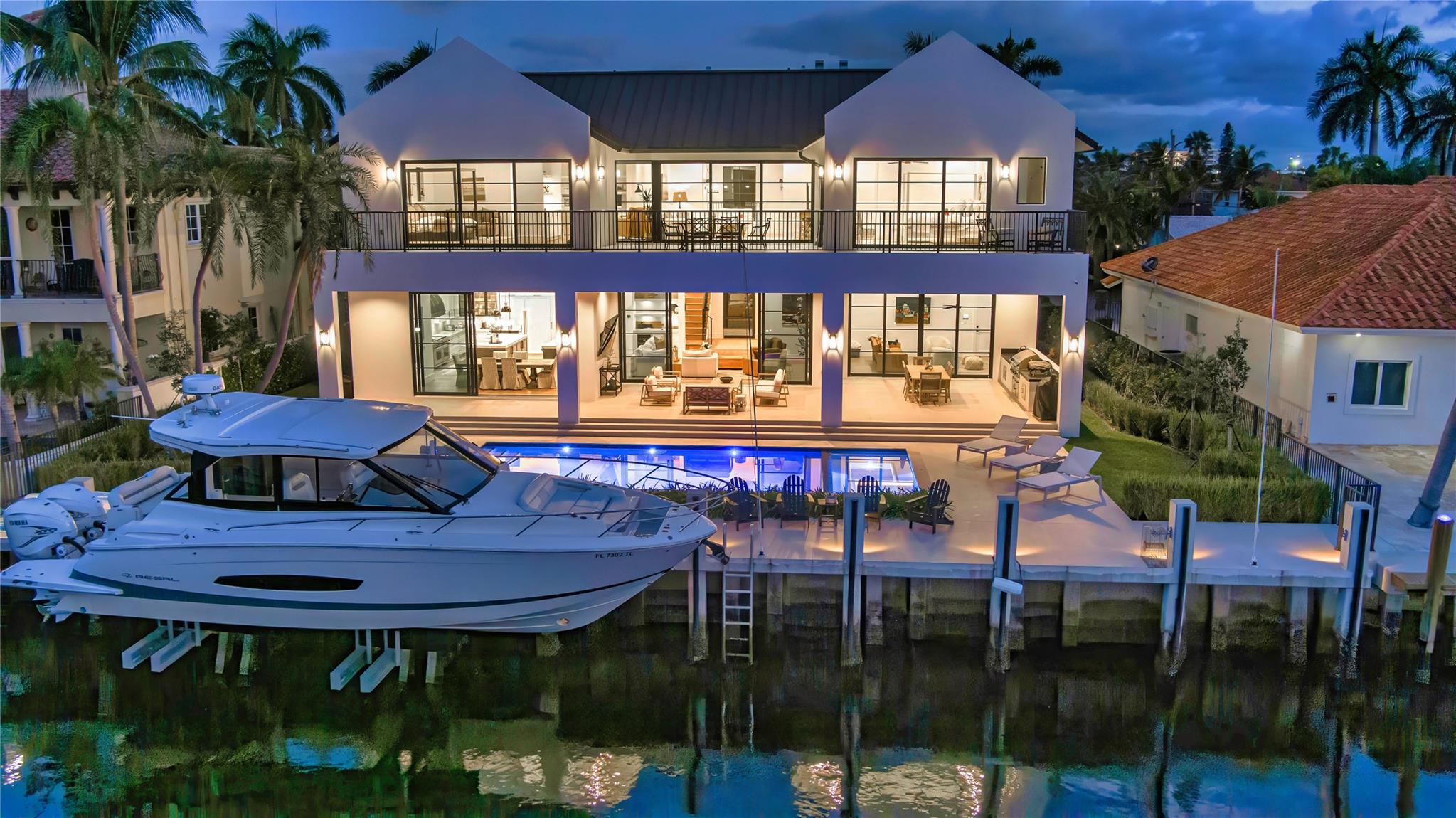 Coastal-Farmhouse Deepwater Estate sited on 90 +/- feet of waterfrontage in the prestigious enclave of Coral Ridge Isles. Masterfully crafted by renowned builder Zahn Development, this residence sets a new standard for living, with craftsmanship and materials that assure peace of mind. Open free-flowing interior spaces with large window walls of sliders are created for indoor/outdoor living. Two-Story, 5 bedrooms, 5 full baths, and 2 half baths. Second level primary suite with sitting room and marble-lined spa-like bathroom. Outdoor entertainment is enjoyed at the south facing pool/patio and spacious covered lanai w/summer kitchen. Ideal for boating enthusiasts, this exceptional estate features a full-service concrete yacht dock with 27,000 lbs boat lift minutes to ocean access. Location: A prestigious, private, and ultra-exclusive enclave in Fort Lauderdale, distinguished by its championship 18-hole golf course designed by the legendary Robert Trent Jones Sr., Coral Ridge Country Club offers a luxury lifestyle amidst a lavish, peaceful and aesthetically pleasing backdrop. The community’s prime location places it just minutes from the pristine Atlantic coastline and a short distance from Fort Lauderdale’s upscale dining, boutique shopping and cultural venues.Property: Residents can indulge in outdoor entertaining on the lanai, complete with a fully-equipped summer kitchen, overlooking the south-facing, sun-splashed, salt-water pool and jetted spa, set within an expansive patio and enveloped in tropical landscaping. Bordering 100 +/- feet on the water and a 90-foot concrete dock featuring a 27,000-pound boat lift, boating enthusiasts enjoy easy access to the intracoastal Waterway and Atlantic Ocean.Residence: In prestigious Coral Ridge Isles, this five-bedroom Coastal-Farmhouse gem, with 7,798 +/- total square feet, masterfully designed and built by renowned Zahn Development, sets a new standard for luxury waterfront living. Bespoke materials, and curated finishes extend throughout, reflecting a commitment to beauty, contemporary design and functionality. Details include handsome wide-plank wood flooring, book-matched marble and custom cabinetry and millwork expertly crafted by local artisans. Introduced by a dramatic two-story foyer with an attractive open stairway, the living room and dining area are topped by beamed and coffered ceilings, respectively, with highlights that include a gas fireplace with a stone surround and a built-in bar with an undercounter wine fridge. In an open-floorplan configuration, they adjoin effortlessly with the gourmet kitchen centered on two islands and fitted with white custom cabinetry, marble counters and backsplashes, a pantry, and professional-grade stainless-steel appliances. Window-walls of glass sliding doors from these areas, along with the adjacent media room, open to the lanai offering serene water views and inviting indoor/outdoor entertaining. Also on the first floor are a well-appointed theatre room, guest-bedroom suite, a powder room, a cabana bathroom, and two attached air-conditioned garages, one with two bays, and the other set up as a gym. On the second level, a family room serves three guest bedroom suites and the primary suite. In a split-bedroom plan, the primary suite, a serene retreat, comprises a bedroom with a sitting room, two large walk-in closets, and a spa-like bathroom, with dual vanities, a free-standing Kallista marble soaking tub, large walk-in marble shower with multi shower heads, and two water closets. Overlooking serene water views, the family room, primary bedroom, and a guest bedroom access an expansive balcony. Amenities include a convenient second-floor laundry, three-zone air-conditioning with linear diffusers, smart home controls, motorized window treatments, security system, gas generator, and trimless lighting. An extraordinary opportunity, this exceptional waterfront haven exemplifies the embodiment of modern luxury living.DISCLAIMER: Information published or otherwise provided by the listing company and its representatives including but not limited to prices, measurements, square footages, lot sizes, calculations, statistics, and videos are deemed reliable but are not guaranteed and are subject to errors, omissions or changes without notice. All such information should be independently verified by any prospective purchaser or seller. Parties should perform their own due diligence to verify such information prior to a sale or listing. Listing company expressly disclaims any warranty or representation regarding such information. Prices published are either list price, sold price, and/or last asking price. The listing company participates in the Multiple Listing Service and IDX. The properties published as listed and sold are not necessarily exclusive to listing company and may be listed or have sold with other members of the Multiple Listing Service. Transactions where listing company represented both buyers and sellers are calculated as two sales. “No payments made until title passes” Some affiliations may not be applicable to certain geographic areas. If your property is currently listed with another broker, please disregard any solicitation for services. Information published or otherwise provided by seller, listing company or its representatives is deemed reliable but are not guaranteed and subject to errors, omissions, or changes without notice. Copyright 2025 by the listing company. All Rights Reserved.
