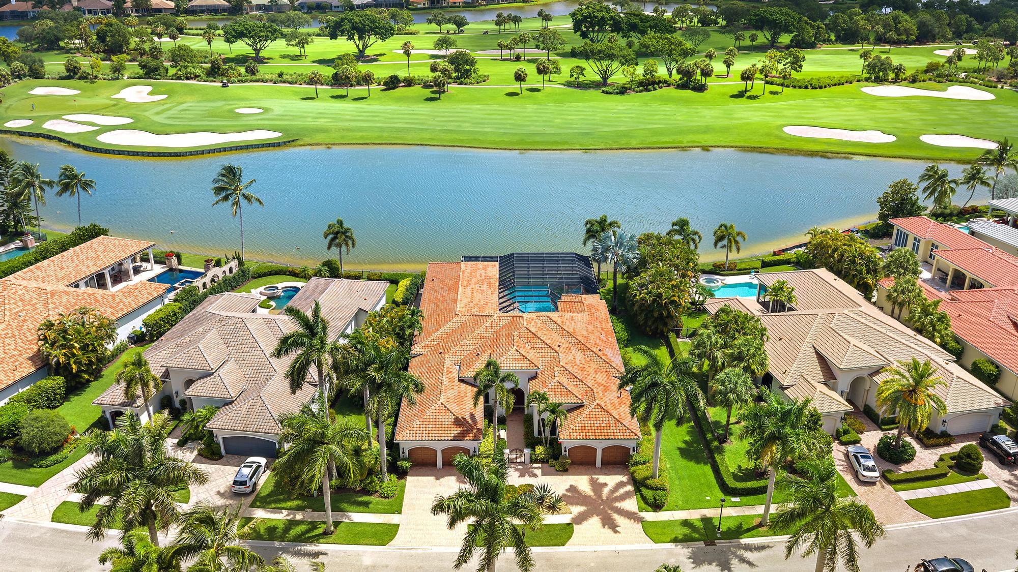 Situated on one of the most extraordinary water and golf homesites in all of The Club at Ibis, this extensively customized Kenco-built estate captures breathtaking panoramic vistas overlooking the 12th hole of the Tradition Course. Spanning more than 5,200 square feet on one level, this rarely available 5BR/5.5BA + Theater estate offers a remarkable combination of scale, architectural presence, and seamless indoor-outdoor living—all beautifully positioned on one of Ibis's most unforgettable lots. Thoughtfully designed and richly appointed, the home features soaring ceilings, expansive living spaces, marble flooring, custom built-ins, and a flowing floor plan ideal for both elegant entertaining and comfortable everyday living. Fully impact glass throughout and enhanced by a 2024-replaced roof, this move-in-ready residence delivers both sophistication and peace of mind.  The outdoor environment is truly exceptional. Invisible corner sliders dissolve the boundaries between interior and exterior spaces, opening to a spectacular fully screened lanai with partially covered outdoor living areas, an infinity-edge pool and spa, and sweeping water and golf views that create a true resort atmosphere. The pool and spa heater were replaced in 2026, further enhancing the home's turnkey appeal.  The spacious primary suite serves as a private retreat with oversized closets, custom built-ins, and serene views of the pool and golf course. An additional bedroom was thoughtfully added to the rear of the home to maximize the property's extraordinary vistas. The impressive theater room overlooks the infinity pool and lake beyond, creating a unique and elevated entertainment experience rarely found within Ibis.  Additional highlights include a whole-house water filtration system, a three-and-a-half garage spaces,  along with a circular driveway providing dramatic curb appeal and ample guest parking. Furniture and artwork are included, allowing for immediate enjoyment of this beautifully furnished turnkey opportunity.  This is a rare offering where premier lot placement, timeless architecture, incredible scale, and breathtaking outdoor living converge to create one of the most compelling estate properties within The Club at Ibis.  Located within The Club at Ibis, a Platinum Club of America, residents enjoy access to one of South Florida's most celebrated private club lifestyles, featuring a 90,000-square-foot clubhouse, three Nicklaus-family championship golf courses, exceptional dining venues, a world-class fitness complex and spa, and premier tennis and pickleball facilities. Renowned for its vibrant social atmosphere, extraordinary amenities, and unmatched lifestyle, The Club at Ibis offers luxury living at the highest level.