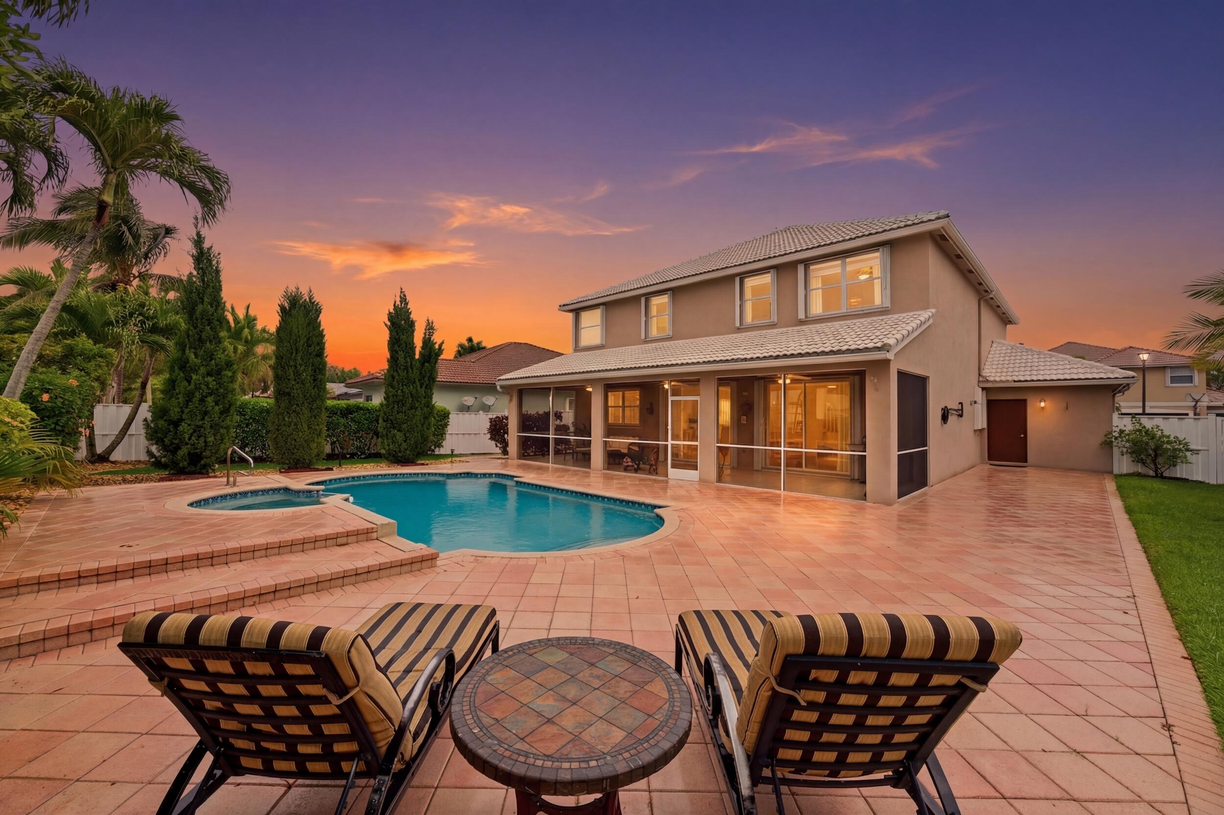 This beautiful family home in the exclusive gated community of Pembroke Shores offers 5 bedrooms and 2-1/2 bathrooms. A beautifully landscaped pool and outdoor area provides a one-of-a-kind oasis with privacy and seclusion. This special home stands out with its soaring Cyprus trees and large enclosed patio for outdoor dinning and entertainment. Offering a three-car garage on a quiet and sought-after street, this home has high ceilings, tons of natural light, and a chef's kitchen, creating an inviting space for family and friends. Located near A-rated schools, shopping, dining, and major highways—this is a rare opportunity that won't last long. Sits on one of the largest lots in the community.