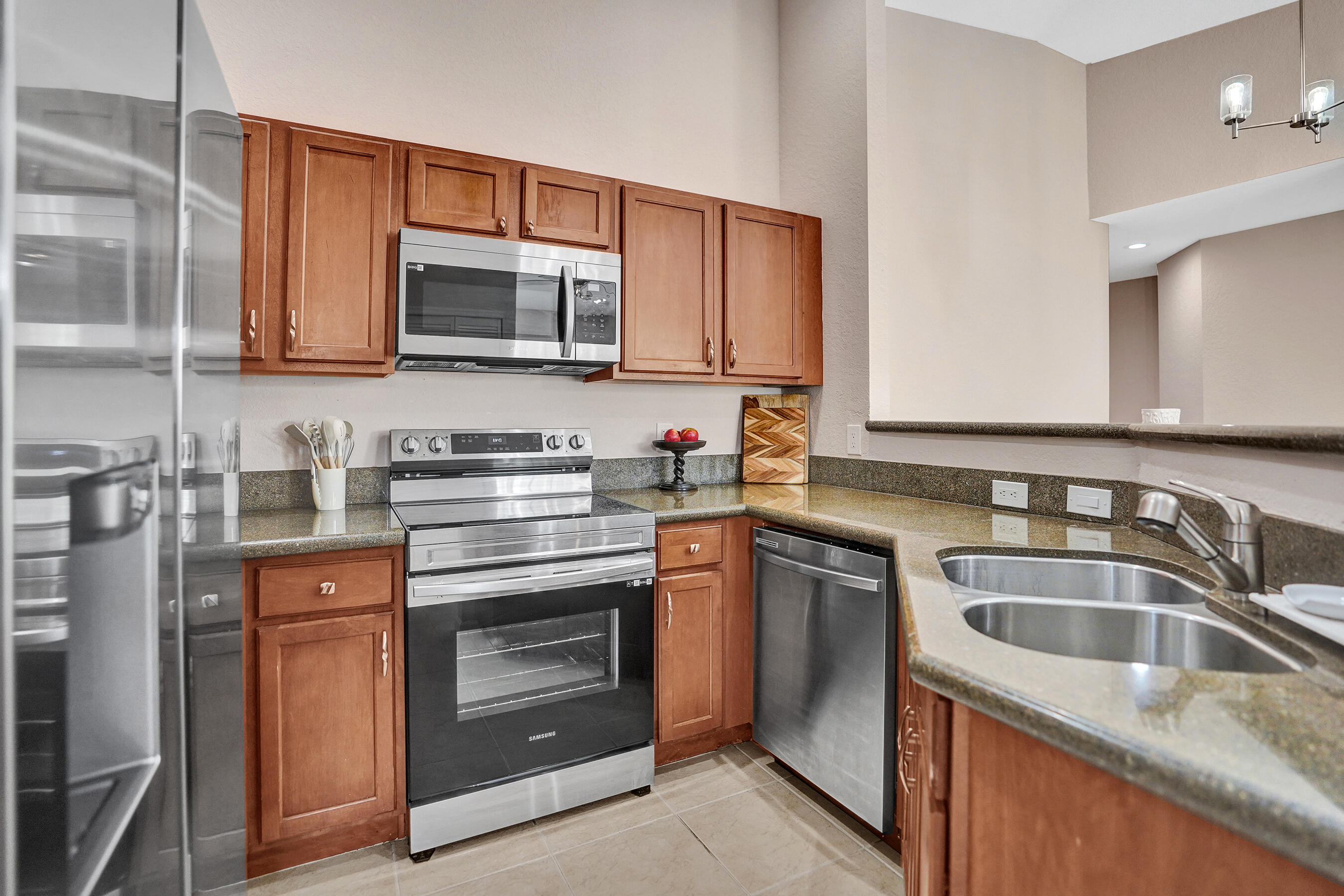 Motivated seller! This move-in-ready 2-bedroom, 2-bath townhome is located in a charming gated community just minutes from the beach. The home features a split floor plan, open-concept living, and a 1-car garage plus driveway parking. Enjoy a large covered balcony accessible from both the living room and primary bedroom. Upgrades include granite countertops, stainless steel appliances, newer washer and dryer, and hurricane shutters for added peace of mind. Ideally located near Singer Island, beautiful beaches, and top-rated shopping and dining, this home offers the perfect blend of comfort, convenience, and coastal living.