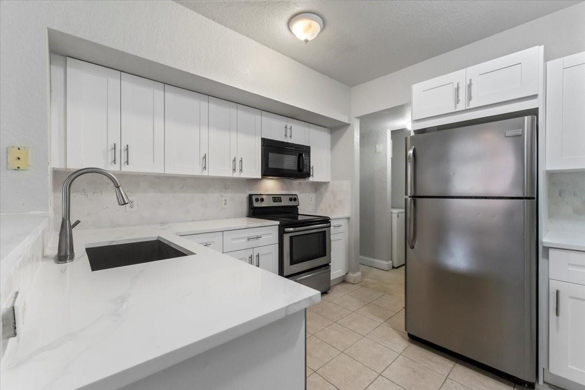 INVESTORS ONLY : Gated community offering luxury, convenience, and investment potential! Current tenant in place until March 2027 PAYING $2,050. This 2 bedroom, 2 bathroom condo features an open-concept layout and spacious living areas. New flooring, stair carpet,  kitchen cabinets and bathroom vanities.  Resort-style amenities, including a sparkling pool, fitness center, and clubhouse. Located just minutes from shopping, dining, and entertainment, t Don't miss this incredible opportunity Schedule your showing today.