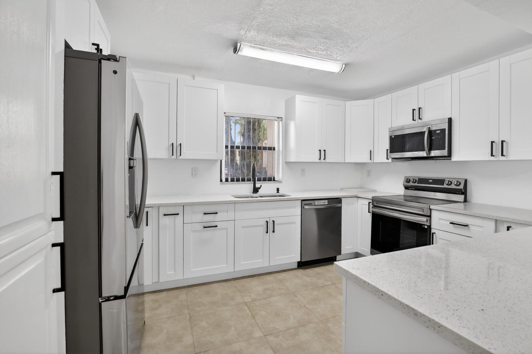 Saturday morning at the community pool, the tennis courts a short walk away, and you come home to a townhouse where the roof, the insurance, and the yard simply aren't your problem. This is the version of Florida living that lets you actually enjoy it — updated, move-in ready, and built for weekends spent how you want with your family and/or pets. Inside, 1,780 sq ft of remodeled space holds three bedrooms, 2.5 baths, engineered wood floors, and a private patio, and the $625 monthly HOA covers roof repairs, structural maintenance, pool service, grounds, and trash. All of it sits in Plantation's established Chateaulaine community, zoned for Central Park Elementary, Plantation Middle, and Plantation High. Schedule your private showing today. *Listing is virtually staged*