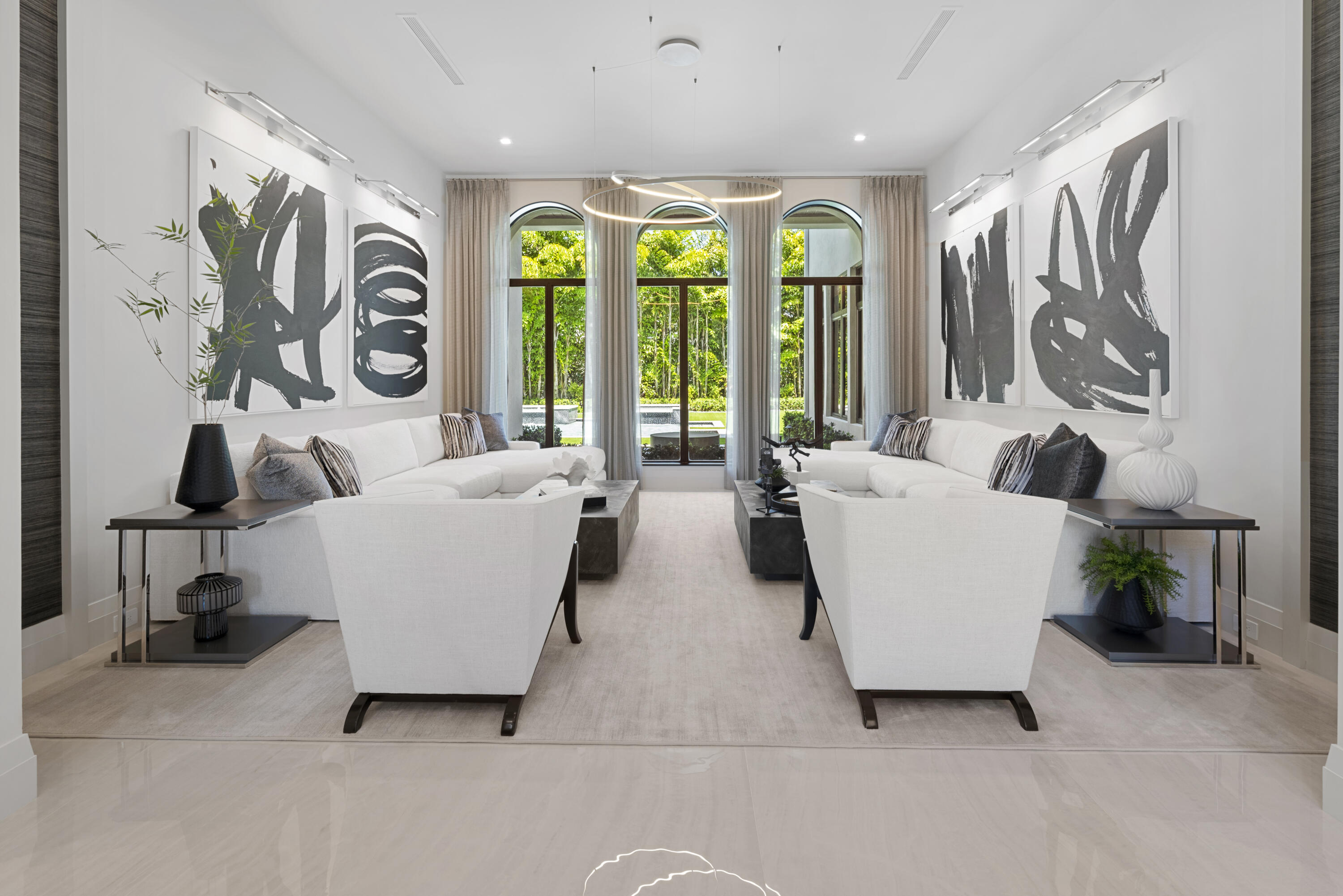 Experience luxurious living in this custom-built residence by Estate Development boasting award winning interior design firm P&H Interiors. 
This sprawling estate underwent an extensive renovation, reimagining every detail from the interior and exterior to the outdoor landscaping and grounds.  This estate features 8 bedrooms, 9 full bathrooms, 3 half baths, a gourmet chef's kitchen, home theatre, office, loft, impact windows and doors, a circular driveway and 3 car garage. As you enter through the grand double-door entry into the foyer with 23 foot high ceilings you will be captivated by the exquisite design and architectural details of this one of a kind property. A floating glass and wood staircase, a barrel ceiling in the dining room, porcelain and wood floors, and dual islands in the kithchen, no detail was spared. An oversized family room is drenched with natural sunlight and overlooks the covered patio and backyard. The expansive master suite boasts his and her bathrooms and dressing rooms. Enjoy the Florida sunshine in your own private outdoor oasis. Heated salt water swimming pool, oversized spa, cascading fountains and an expansive covered patio complete with an outdoor kitchen. As you make your way upstairs, you are greeted by a show-stopping office, a comfortable movie theater for the family, and a separate loft area with 6 en suite bedrooms, providing ample space for privacy and relaxation. This home is located in the Devon Place subdivision of Woodfield Country Club, a private but active country club community that is centrally located and offers a multitude of high-end amenities that make the South Florida lifestyle so remarkable.