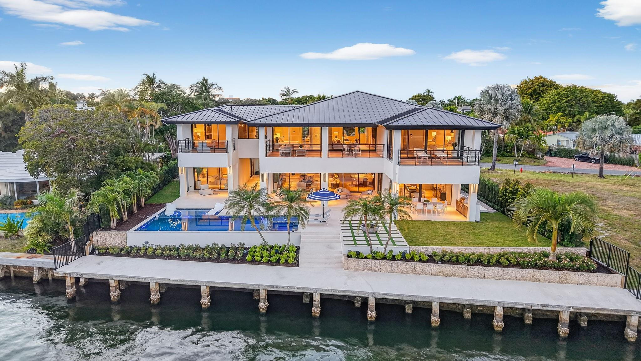 Located on a premier direct Intracoastal isle overlooking Birch State Park, this estate sits on nearly 16,000 sf with 100 ft of waterfront. Wide open water views from almost every room highlight the collaboration between architect Bob Tuthill, builder JL LaVallee, and designer Alex Thies. Over 2,300 sf of covered outdoor living complements a thoughtful floorplan with a separate guest house, five air-conditioned garage bays, and a gated motor court. Features include Lutron, Lennox systems, chef's kitchen with SubZero and Wolf appliances, wine room, private primary suite with spa bath, office, and upper-level club room. CO 12/25. Seller financing available. - Residence is surrounded by multiple outdoor entertaining areas (2,232 ssf of covered outdoor living areas) comprising rear terraces & expansive covered balconies for the second level family room, primary suite and bedroom suites 2 and 3.- 5 air conditioned garages, 3 in main residence & 2 incorporated into the guest house with gated motor court, great for privacy, security or children's play area. Two separate, dedicated driveways.- Private guest house is separated by the picturesque breeze way adding to the island and coastal modern ambiance of this exceptional residence.- Heated salt water pool with beach ledge (extending 21 ft wide) and 8x6 ft spa.- Covered rear terrace adjoins the dining and living areas, complete with hidden rolldown hurricane screens & drop down TV.- Separate dedicated home office (not included in the bedrooms) also features a private balcony.