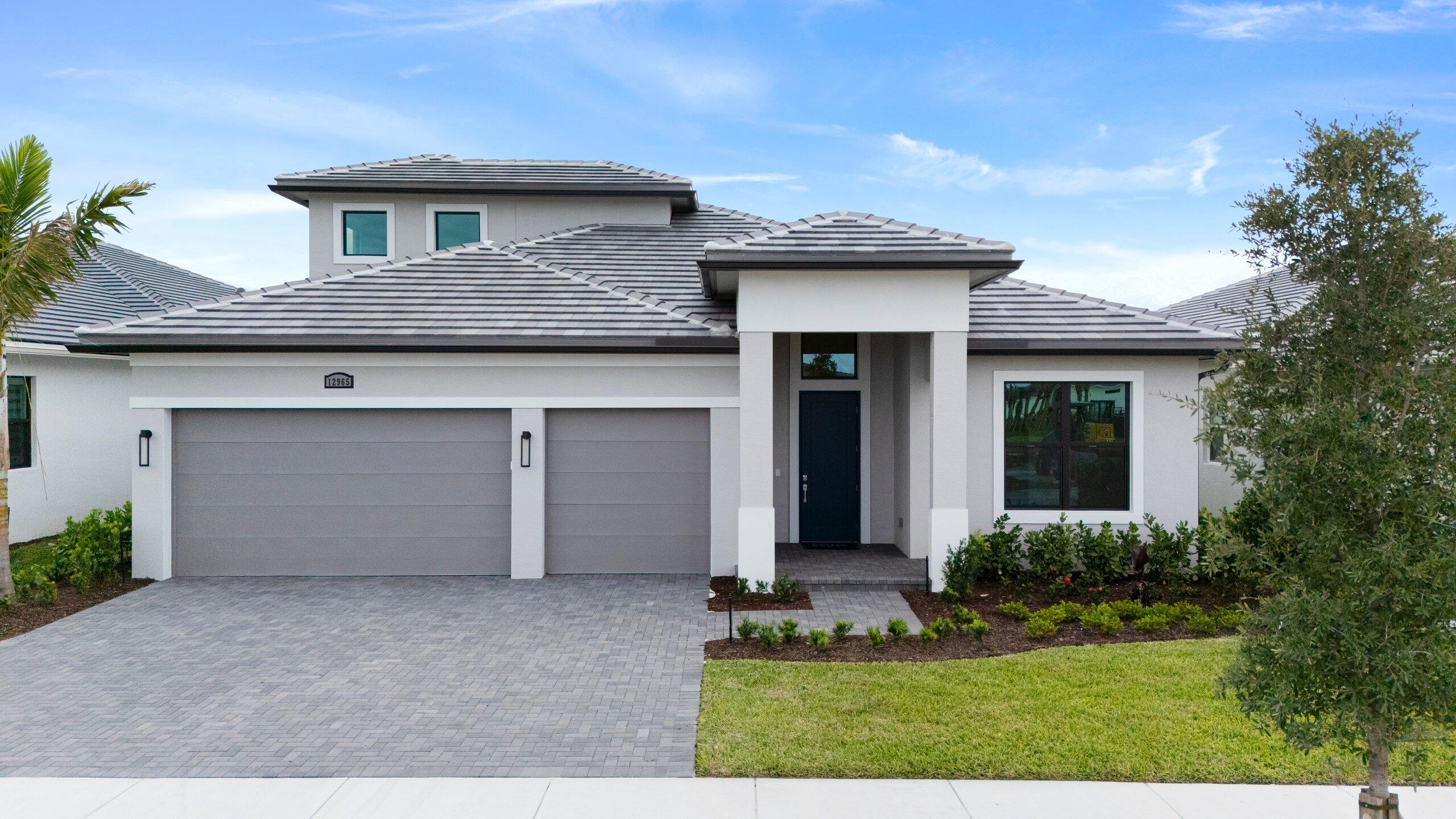 This thoughtfully designed home showcases timeless transitional styling with a clean, sophisticated exterior palette accented by bronze windows, coordinated roofing, and elegant paver details that enhance its curb appeal. Open living spaces are complemented by upgraded flooring, recessed lighting, and refined finishes throughout. Gourmet kitchen serves as a true centerpiece, featuring elevated cabinetry, quartz countertops, premium appliances, custom lighting, and sleek details ideal for both casual living and entertaining. Owner's suite offers a spa-inspired retreat with a frameless, floor-to-ceiling tiled shower, generous walk-in closet, and modern finishes.   Situated within a gated community offering a clubhouse and full resort-style amenities.  Discover luxury living at PGA Village Verano, with resort-style amenities: private Pickleball Center with 27 courts, fitness facilities, indoor and outdoor pools, tennis, bocce, and basketball courts. Includes access to PGA Golf Club for its members, plus billiards, library, kitchen, and a full-time Lifestyle Director.