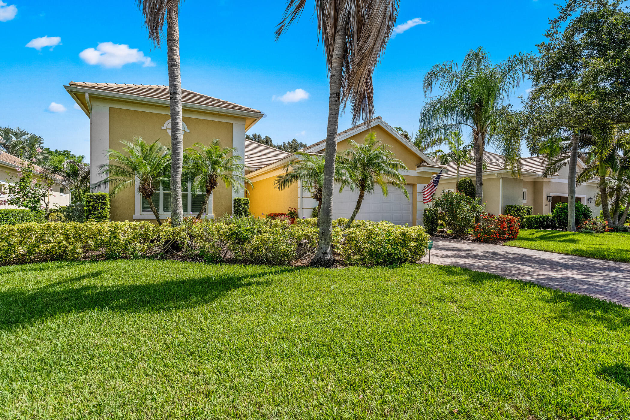 Beautiful expanded Ashley model with 4 bedrooms and an extra-long 25+ft. garage- perfect for a truck or large SUV. The spacious island kitchen with solid maple cabinetry opens to an extended family room, while the generous primary suite provides a relaxing retreat.Tile floors throughout are accented by a custom mosaic medallion in the foyer. Additional features include plantation shutters, crown molding, wet bar, central vacuum, impact doors and windows and a large screened lanai overlooking an oversized, private, lushly landscaped lot. Near beaches, shopping, golf and medical facilities.