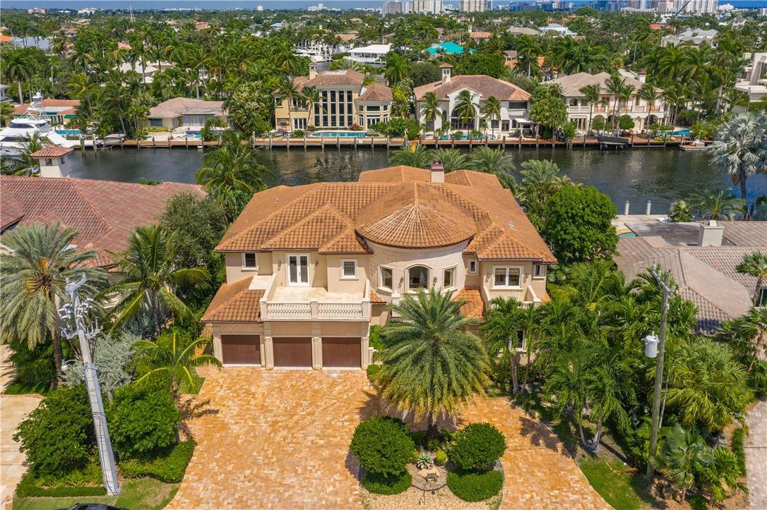 Amazing opportunity!! Home is located in the highly desirable and gated Harbor Beach community. Just minutes away from the Intracoastal, you are greeted by an open floor making the home perfect for indoor and outdoor entertaining. Exclusive interior items include custom chef's kitchen with superior appliances, a Media room, formal dining room, gym, office, interior & exterior cameras and an elevator. 1 master suite is located on the ground floor, the other master is upstairs and includes a large walk-in closet. Enjoy the outdoor space this home has to offer with a 45' heated pool, outdoor BBQ, spa and a  "swim up" wet bar. 95' on the water with accommodation for up to a 75’ yacht. Jet ski davit & boat lift. Private Harbor Beach Surf Club and Marina Membership available.