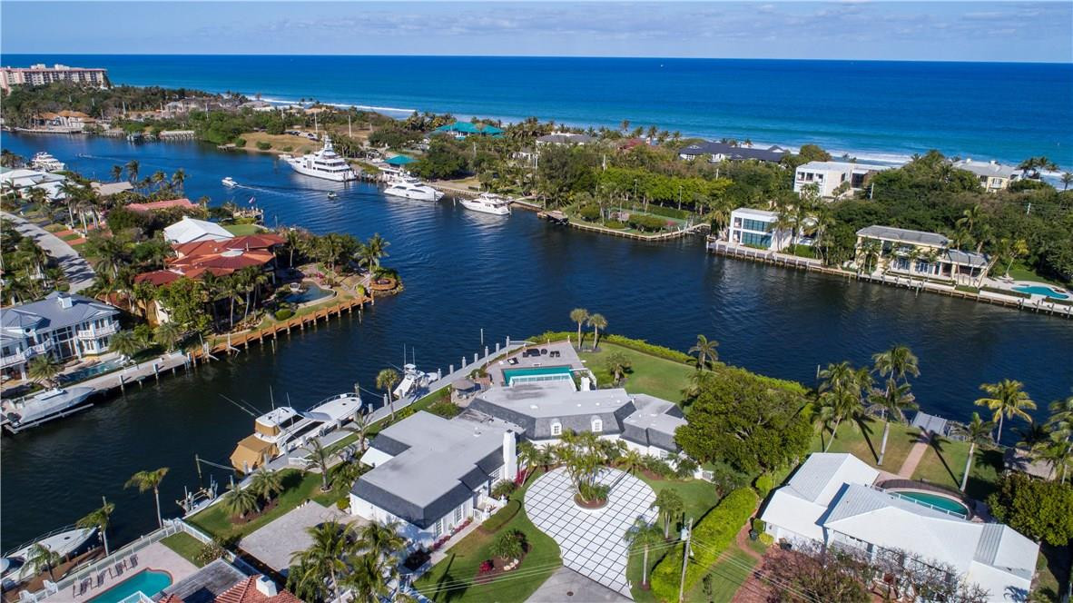 Stately Regency-inspired Intracoastal Point Estate sited on just under 1 acre (2 lots) and402+/- feet of total water-frontage with 224+/- feet of protected side yacht dockage on the North Grand Canal. A trophy setting with an elegant residence reminiscent of Bel-Air or Palm Beach estate living overlooking the world class estates of Hillsboro Mile. Sprawling resort-style pool w/expansive marble patio and verdant lawn for entertaining. A defining opportunity to re-imagine or re-develop. Adjacent south lot (MLS: F10149755) can be purchased and combined for a total of 502’+/- of waterfrontage and 1.39+/- acres (60,596+/- SF) for the ultimate waterfront setting.Shown by appt. only