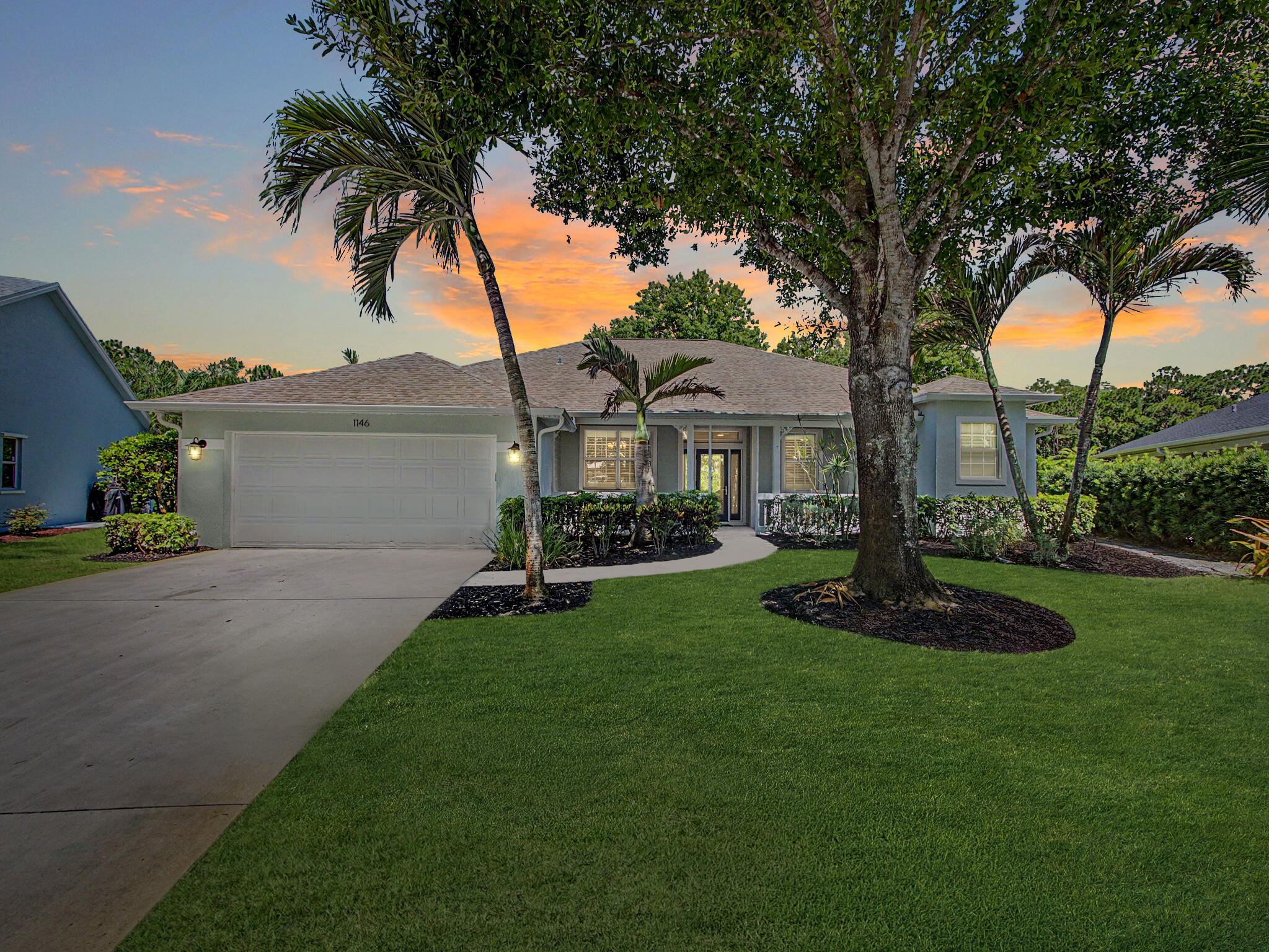 Rare Opportunity in Palm City's Oak Ridge community!  Nestled in the shade of mature live oaks, this meticulously cared-for lakefront home is the perfect combination of tasteful updates with the ideal location.  Enjoy the private feel of the cul-de-sac location from your front porch, and then take in the serenity of the lake vista from the screened rear lanai.  Inside, the floor plan is the perfect blend of open but defined spaces, including two living areas and a dining room, and every lifestyle can be tailored to the best use of space.  Tasteful interior updates to the kitchen and baths, including striking quartz counters, newer appliances, plantation shutters, and cabinetry.   Primary suite is split from the two guest rooms, and the floor plan also offers a dedicated flex room -  perfect as an office, nursery, or fourth bedroom.  Impact windows and doors, new washer and dryer (2025), and a newer roof (2021) add to the peace of mind.   Garage is deeper, even allowing for some boats/trailers to be stored inside.  Few homes of this level come available in Oak Ridge, and for good reason.  The community features a clubhouse and pool, tennis, and private boat ramp with ocean access in a perfect central location to schools, downtown Palm City attractions, and highway access!