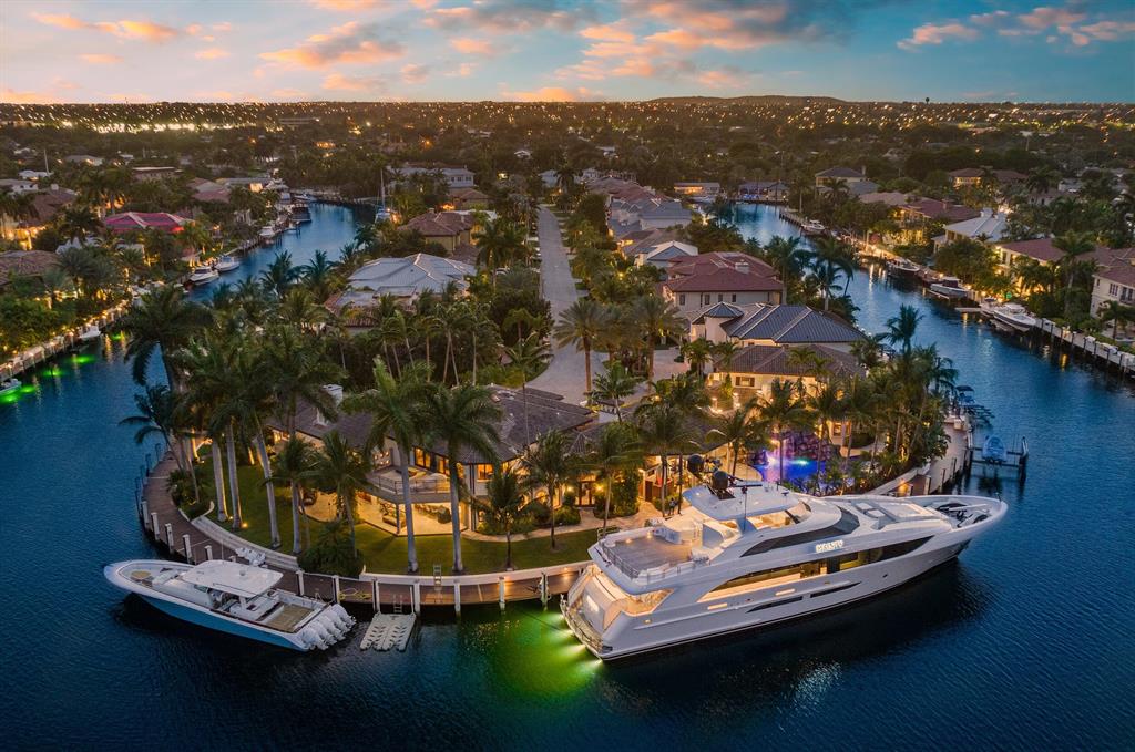 Introducing Aqua Del Mar, an expansive double point gated estate located in Lighthouse Point. This remarkable property boasts an incredibly rare 400 feet of deep water frontage with ocean access, with panoramic views of the waterway. Enveloped by the tranquil ambiance of swaying palm trees and natural surroundings, Aqua Del Mar is an ideal getaway for aficionados of Florida's luxury lifestyle, as well as yachting and car enthusiasts. 

The estate comprises of a primary residence and a separate guest house, encompassing 8 bedrooms, 7 full bathrooms, 3 half bathrooms, and an impressive 8,800 SF of living space (with over 10,100 SF overall). The main house features a remarkable great room filled with natural light, providing an exceptional setting for entertaining guests or unwinding with loved ones. Adjacent to the great room is a renovated kitchen, spacious family/media room, ideal for movie nights or watching sports events. The sophisticated club room, complete with a professional style bar, is an excellent setting for hosting formal gatherings or casual get togethers with friends and family.
The grand primary suite, a sanctuary of convenience and comfort, includes a private sitting area, and a spa-inspired ensuite bathroom with a soaking tub and separate shower.
The enchanting outdoor spaces overlooking the water, a tropical oasis that captivates with rock waterfalls, a slide and a grotto extends the estate's entertaining vibe. The impeccably landscaped pool area, brimming with lush foliage, is surrounded by a large deck that provides ample space for lounging and soaking up the Florida sunshine.
For boating enthusiasts, the property offers dockage that spans more than 400 feet (enough for multiple yachts) just minutes from the Hillsboro inlet, making this double point compound the ultimate waterfront retreat. 
With its luxurious amenities, stunning views and idyllic location, Aqua Del Mar is the epitome of sophistication and the perfect place to call home.