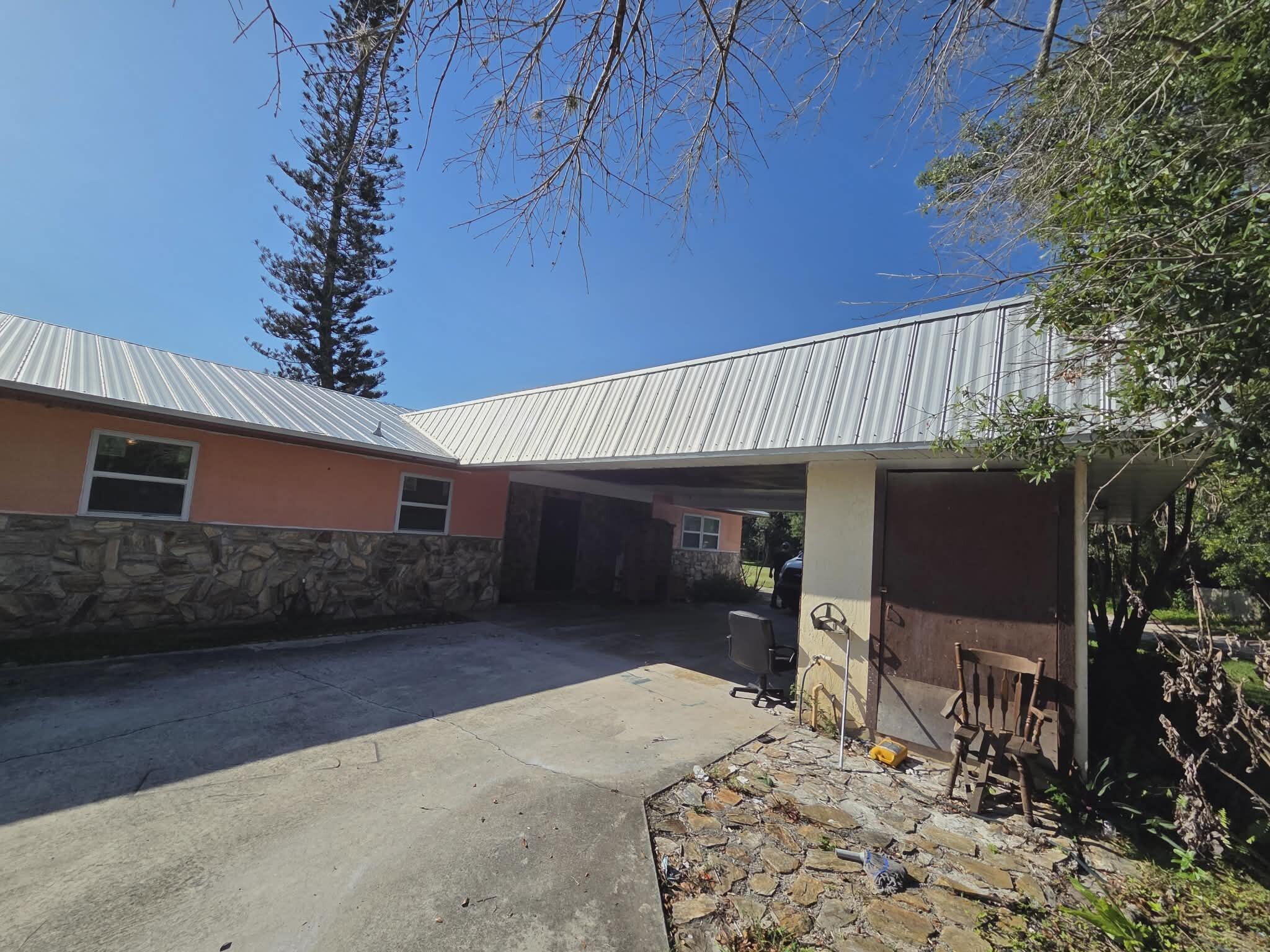 Country Living at Its Best! 4 Bedroom/2 Bath 2464' under roof, 1702" under air on 1 Acre.  New metal roof (2024), new impact windows and doors, new paint inside and out, new djainfield and 32"x32" tile throughout.  New kitchen with all wood cabinets, stainless steel appliances and quartz countertops will be completed by closing.  Easy commute ! 5 minutes to I95 and Orange Ave.