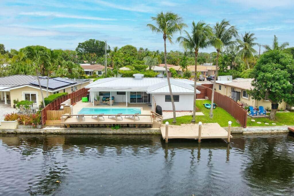 Welcome to this exceptional 3 bedroom, 2 bathroom waterfront estate offering 2,127 square feet of beautifully renovated living space, a private heated pool, private dock with room for a boat up to approximately 35 feet, and stunning canal views just minutes from the ocean! Located in desirable Fort Lauderdale, just across the bridge from Wilton Manors, this move-in ready home features a NEW metal roof, complete impact windows and doors, fully renovated interiors, updated electrical wiring, a designer kitchen with custom white cabinetry, high-end appliances, quartz countertops, and elegant ceramic tile flooring throughout. Combining luxury upgrades, outdoor living, and boating convenience, this home offers the ultimate South Florida lifestyle. From the moment you arrive, you will appreciate the attention to detail and thoughtful renovations throughout this incredible property. The gourmet kitchen is truly the heart of the home, featuring beautiful custom cabinetry, premium appliances, quartz countertops, a spacious island, and modern finishes perfect for entertaining family and friends.  The thoughtfully designed split-bedroom floor plan provides privacy and comfort, with three spacious bedrooms, two fully renovated bathrooms, a large family room, and an open layout designed for today's lifestyle. The primary suite and living area flow seamlessly to the covered outdoor deck, creating the perfect indoor-outdoor connection while overlooking peaceful canal views.  Step outside and experience true waterfront living with a newly heated private pool, covered patio, outdoor entertaining area, and private dock with direct water access. Whether you are enjoying morning coffee by the canal, hosting friends by the pool, or heading out for a day on the water, this backyard delivers the perfect Florida lifestyle.  Located in the desirable Poinsettia Heights River Addition neighborhood, this home places you in the heart of Fort Lauderdale's best attractions. Enjoy being just minutes from the world-famous Fort Lauderdale beaches, Las Olas Boulevard, Wilton Manors, and an incredible selection of restaurants, nightlife, shopping, and entertainment. Spend your days relaxing by the ocean, exploring local boutiques, enjoying waterfront dining, or experiencing everything this vibrant South Florida community has to offer.  Conveniently located near major roadways, grocery stores, parks, coffee shops, and everyday amenities, this property offers the perfect balance of peaceful waterfront living and easy access to everything Fort Lauderdale has to offer.