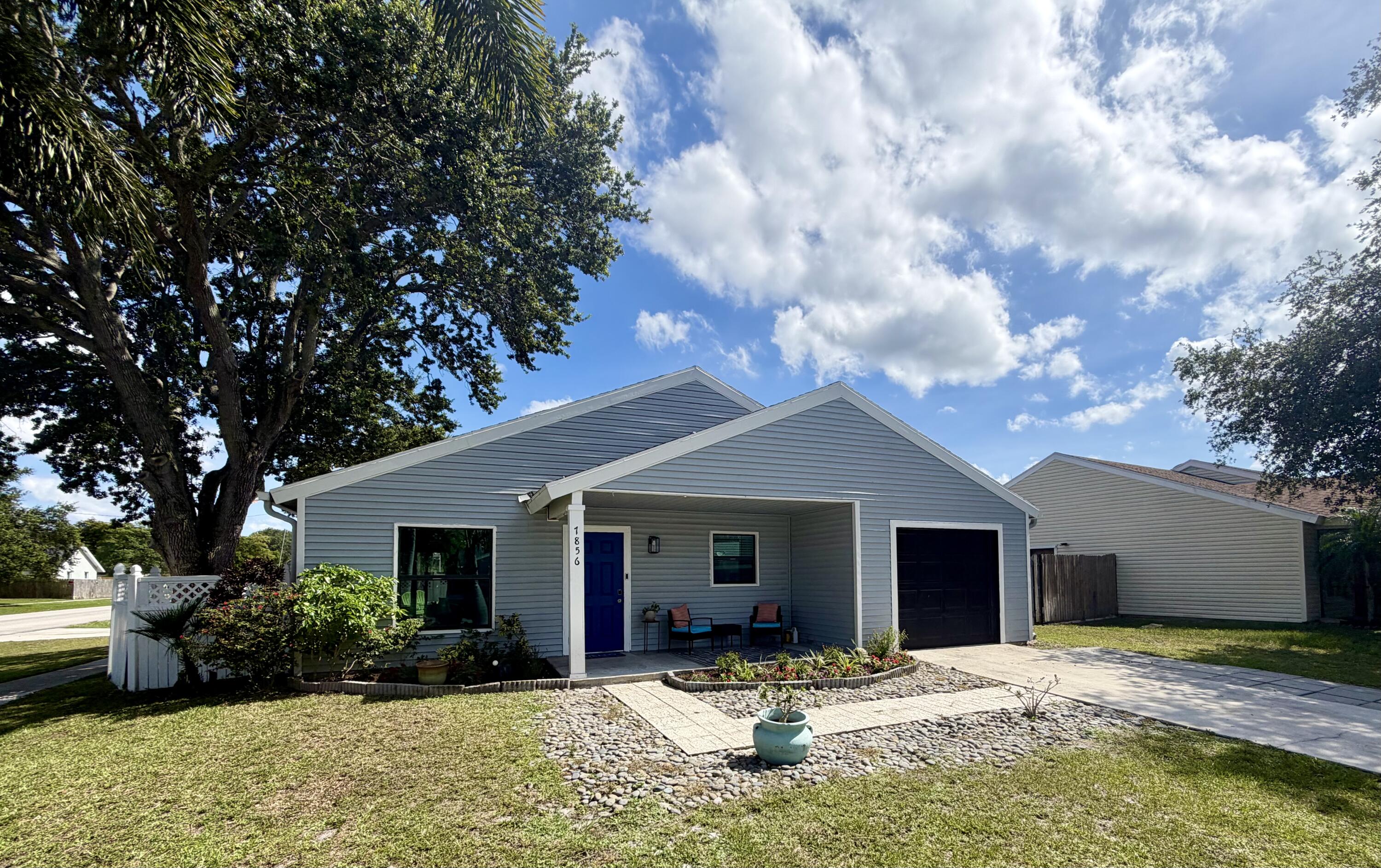 Beautifully updated one-story home featuring 2 bedrooms, 2 bathrooms, and a finished garage that can easily serve as a third bedroom, office, or flex space. Offering 1,600 sq/ft of living space, this home sits on a spacious corner lot with a huge backyard—perfect for entertaining, outdoor living, or adding a future pool.  Recent upgrades include impact windows throughout, a wind-mitigation-approved front door, new tile flooring, updated kitchen, appliances, and plumbing, plus smart home features such as a smart thermostat and lighting. Additional highlights include a Ring security system, irrigation system, storage shed, and an extended driveway. The HVAC system installed in 2022.  Conveniently located near the Turnpike, top-rated schools, shopping, dining, and beautiful beaches!  Refrigerator in the utility/laundry room does not convey.  3rd nail in roof straps for additional insurance discount