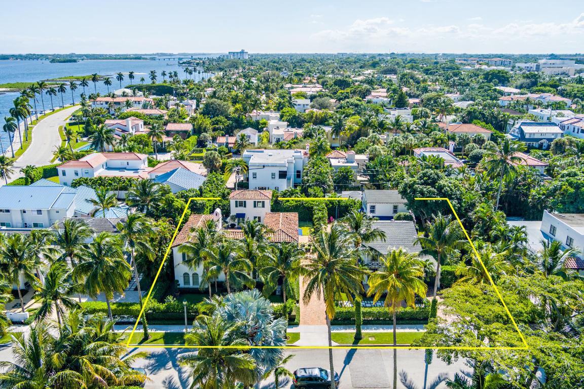 A unique one-of-a-kind compound in one of the most sought-after neighborhoods in West Palm Beach with approximately 7,350 sq ft on just under half an acre. Nestled in the heart of the El Cid neighborhood, this exceptional property presents incredible living space combined with an outdoor oasis. 256 Cordova serves as the primary anchor of the compound, a 5 bedroom, 3.5 bath residence built in 2015 with elevated finishes and thoughtful design throughout. Enter through the living room to exposed beams and a gas fireplace, leading into the dining area. A separate family room opens to a beautifully appointed Thermador-equipped kitchen featuring an oversized island, wine fridge, and adjacent mudroom. The main level also includes a dedicated office and two bedrooms. Upstairs, a loft with built-in desks opens onto a balcony with beautiful water views. The primary suite offers dual vanities, a Zen Bathworks soaking tub, and dual closets. Two additional bedrooms and a spacious laundry room complete the second floor. Outside, a covered loggia overlooks a serene saltwater pool and a spacious garden. A private two story guesthouse with a full cabana bath on the first floor and a bedroom and half bath on the second floor enhances the flexibility of the property. The home is also equipped with a full house generator.
 
Just across the open lawn is 262 Cordova, a light-filled residence designed for effortless indoor-outdoor living. The inviting living room flows into the dining room and well-appointed kitchen, which extends into a sunroom with access to a ground-level deck overlooking the gardens. Upstairs, the primary suite features an en-suite bath, large walk-in closet, and a balcony offering water views. This home also includes a two-story guesthouse: a lower-level studio suite with a full kitchen and full cabana bath, and an upper-level one-bedroom suite with a kitchenette and full bath -perfect for extended family or guests. 

The shared grounds are where the magic of this compound comes to life. With no barriers between the properties, both homes enjoy access to the lush connected gardens, multiple lounging areas, two saltwater pools, an in-ground trampoline, cold plunge, and a putting green - creating a resort-like environment rarely found in El Cid.

Offered as a complete package, 256 and 262 Cordova together represent a unique opportunity to own a multi-generational compound in one of West Palm Beach's most desirable neighborhoods - ideally positioned within the coveted Palm Beach Public School District and just steps from the Intracoastal Waterway and downtown West Palm Beach.