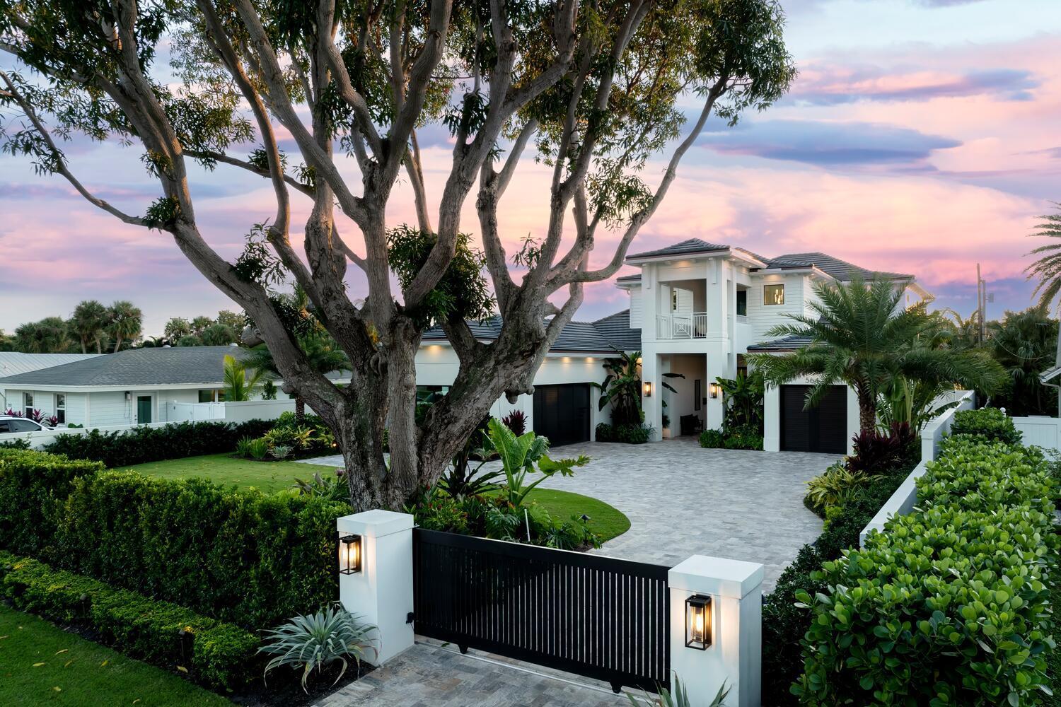 Discover your dream home in this stunning 5-bedroom, 5.5-bath masterpiece, perfectly designed for comfort and entertainment. This property features a spacious porcelained tiled 3-car garage with custom doors, dock, luxury pool and12,000 lb  lift,  all set within a meticulously landscaped exterior featuring a beautiful travertine driveway and walkway. As you enter, you're welcomed into an elegant family room highlighted by an electric fireplace and a wall-mounted TV, showcased on a decorative porcelain slab. Expansive sliders lead seamlessly to the air conditioned lanai, backyard, pool, and dock, creating an inviting atmosphere for indoor-outdoor living.
The gourmet kitchen is a chef's delight, boasting floor-to-ceiling shaker cabinetry with glass door accents. It comes equipped with a full house generator,  premium Thermadoappliances, including a 6-burner gas stove, paneled refrigerator and pantry, and features an island with stunning quartz countertops, and custom pendant lighting, perfect for meal preparation and casual dining. The first-floor master bedroom has his and hers walk-in closets with with built-ins and  dressing area, and  offers a private entry to the pool, yard, and dock. The en-suite master bath features double vanities with a makeup desk, two water closets, a separate walk-in shower, and a relaxing soaking tub for ultimate pampering.
The first floor also includes a convenient powder room, a cabana bath and steam room, a comfortable guest bedroom with its own en-suite bath, along with a well-appointed laundry room equipped with double front-load washers and dryers, a sink, cabinetry,  built in hanging rod, beverage refrigerator and laundry shoot from the primary bedroom and a convenient folding area. A bonus room adds additional versatility with cabinetry, a sink, and ample storage space. Upstairs, the second-floor loft/great room  provides a welcoming space for relaxation or play, while the three additional guest bedrooms each boast en-suite baths and access to the expansive covered balcony, offering beautiful views of the backyard oasis. Step outside to your private paradise, featuring an inviting  pool, a fully-equipped summer kitchen with a bar, sink, refrigeration, weather proofed cabinets and counter seating, all set against a backdrop of lush, fully irrigated turfed landscaping. Additional seating area with a fire pit and a dock provide the perfect setting for outdoor gatherings and water activities. This exceptional home combines luxury, convenience, and a vibrant waterfront lifestyle, making it the perfect retreat for family and friends. Don't miss the opportunity to make this stunning property yours! The Village of North Palm Beach is becoming one of the most sought-after communities in Northern Palm Beach County. It is a coastal community with easy access to both the Palm Beach and Jupiter Inlets for some of the best fishing in the world. Combined with easy access to Palm Beach International Airport, some of the best beaches and a wide range of dining establishments in the area, the village is becoming one of the top communities in Northern Palm Beach County. The village is also home to the newly renovated North Palm Beach County Club, featuring an Olympic swimming pool, splash pad, picnic area, an on-deck tiki hut, 200 seat banquet room, The Clubhouse Restaurant, the Grill Room, the Jack Nicklaus Signature Golf Course, and a full featured tennis facility with Har-Tru courts. It is open to the public and village residents. The village of North Palm Beach was recently designated as a golf cart friendly community.
"Seller shall convey to Buyer  by quit claim deed all of Seller's rights in the submerged lands adjacent to the Property from the south Property line to the centerline of the Earman River between the prolongated east and west property lines of the Property. " 
.91acres total property with water rights. 58 Acres approx. to be conveyed at closing to the buyer. .33 acres of the water rights will not convey at closing to the buyer. Seller will retain this portion of the property. Lot 27, Block 3 , Village of North Palm Beach Plat No. 1