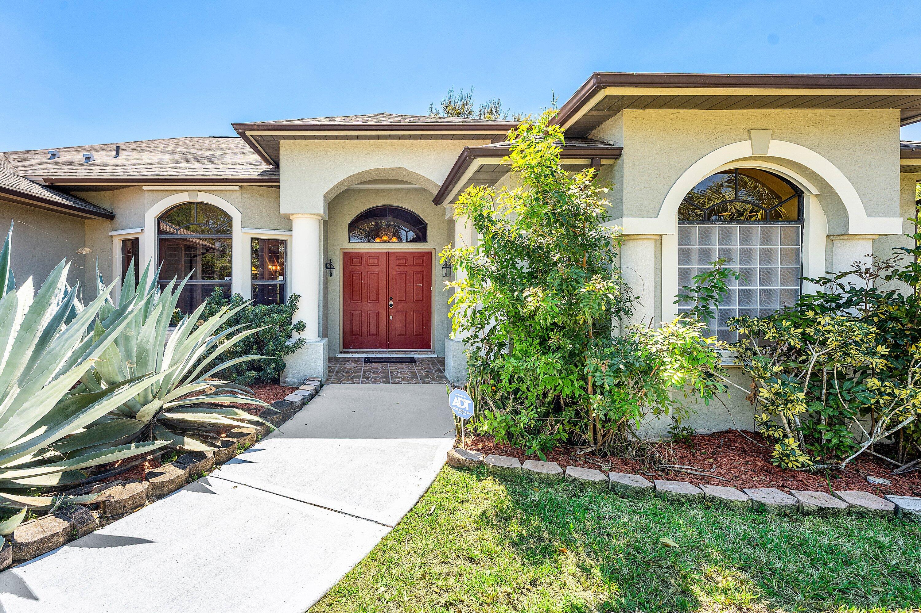 Discover this spacious 3-bedroom, 2-bathroom home with 2,306 square feet of living space located in Port St. Lucie, with easy access to I-95 and the Turnpike. This 2007 CBS home sits on 0.24 acres and features a long driveway and a large fenced backyard. A beautifully landscaped walkway leads you to the double front door. Upon entering, you are welcomed by tile flooring that flows throughout the main living area. Enjoy nice views of the backyard through multiple sliders and doors. The kitchen boasts upgraded cabinetry and gorgeous granite countertops. There is an eat-in kitchen area filled with natural light from windows. An oversized family room adjoins the kitchen, with easy access to the fenced backyard. The split primary bedroom ensures privacy from the additional bedrooms. It includes two walk-in closets and a spacious bathroom with two vanity stations, a separate shower, and a soaking tub. A buried propane tank fuels the gas stove, dryer, and water heater. With a 2023 roof, whole house generator, and storm protection, you can move in with confidence and peace of mind.