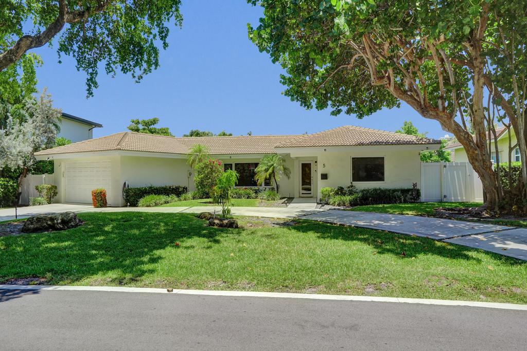 Nestled within the highly sought-after gated community of Sea Ranch Lakes, this beautifully updated 3-bedroom, 3-bath home offers the perfect blend of comfort and coastal living. Residents benefit from it's own police force and exclusive access to a private beach, Beach Club, swimming pool, and playground. The newly renovated 2026 kitchen features stainless steel appliances, Cristallo Quartzite countertop, large center island, ideal for everyday living and entertaining. Recent upgrades include a new tankless water heater, electric vehicle charging station, mini-split A/C in the garage, and freshly painted interior and exterior. A rare opportunity to enjoy modern updates and exceptional amenities in one of South Florida's premier beachside communities.