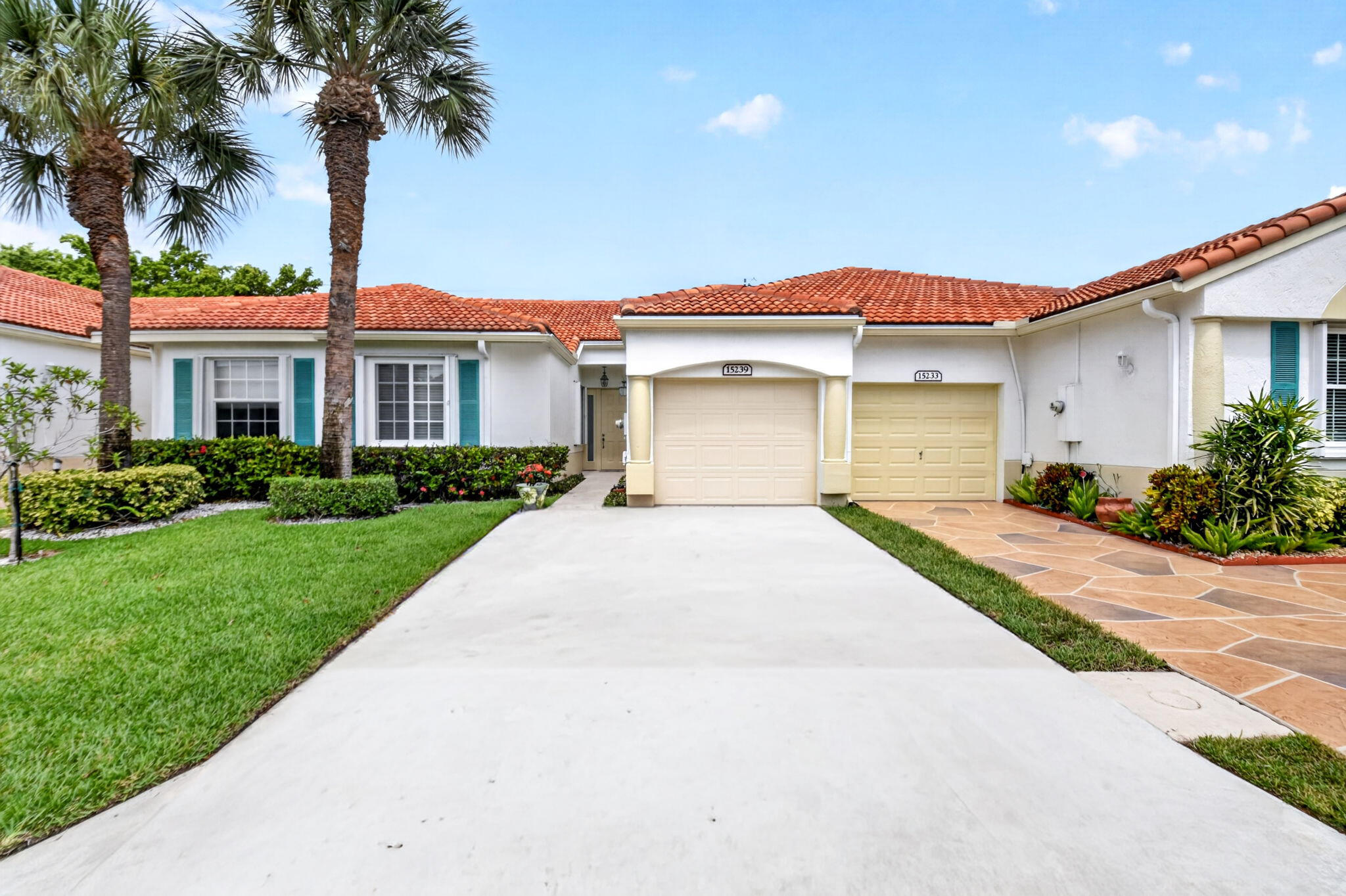 Beautifully updated 2-bedroom, 2-bath villa with a one-car garage in the desirable 55+ community of Floral Lakes. Located in the newer Phase 4 section of the community, this light-filled home features a renovated kitchen with solid wood cabinetry, 42-inch upper cabinets, stainless steel appliances, and a custom coffee and wine bar complete with a wine cooler. Both bathrooms have been completely remodeled, and all light fixtures and ceiling fans have been tastefully replaced throughout the home. Hardwood flooring enhances both bedrooms, while 18-inch tile flows throughout the main living areas.  The spacious primary suite offers a large walk-in closet, while the open living spaces provide a comfortable and inviting layout. Enjoy peaceful outdoor living from the tiled, hurricane-rated screen